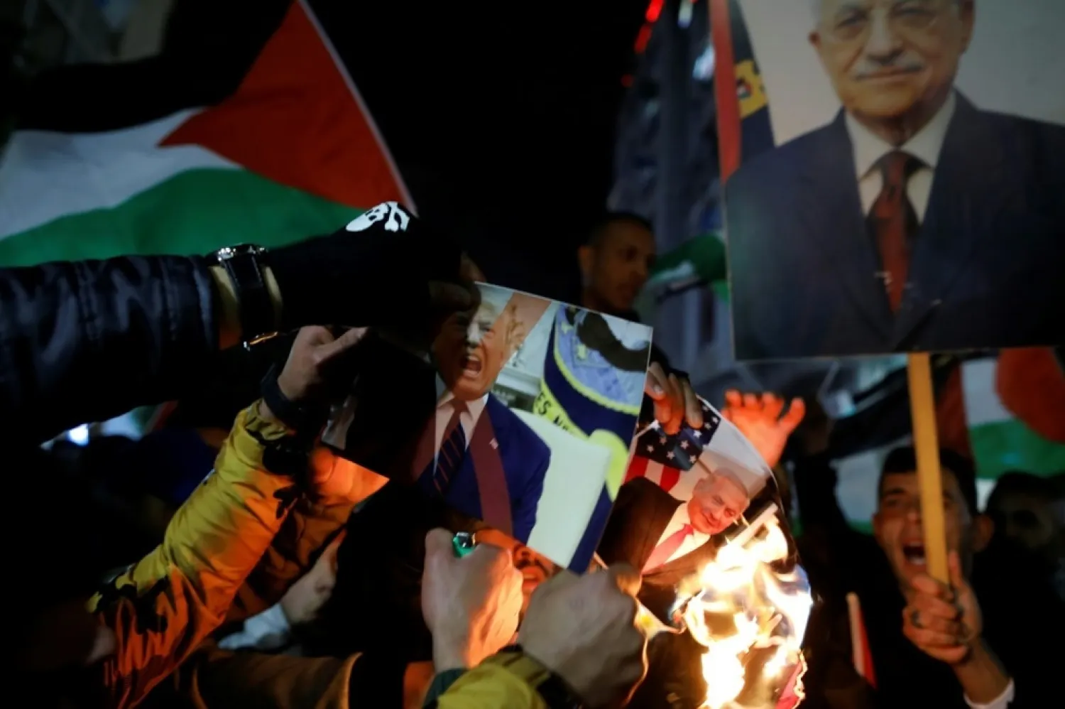 Palestinian protesters in Ramallah burn pictures of Donald Trump and Benjamin Netanyahu | AFP