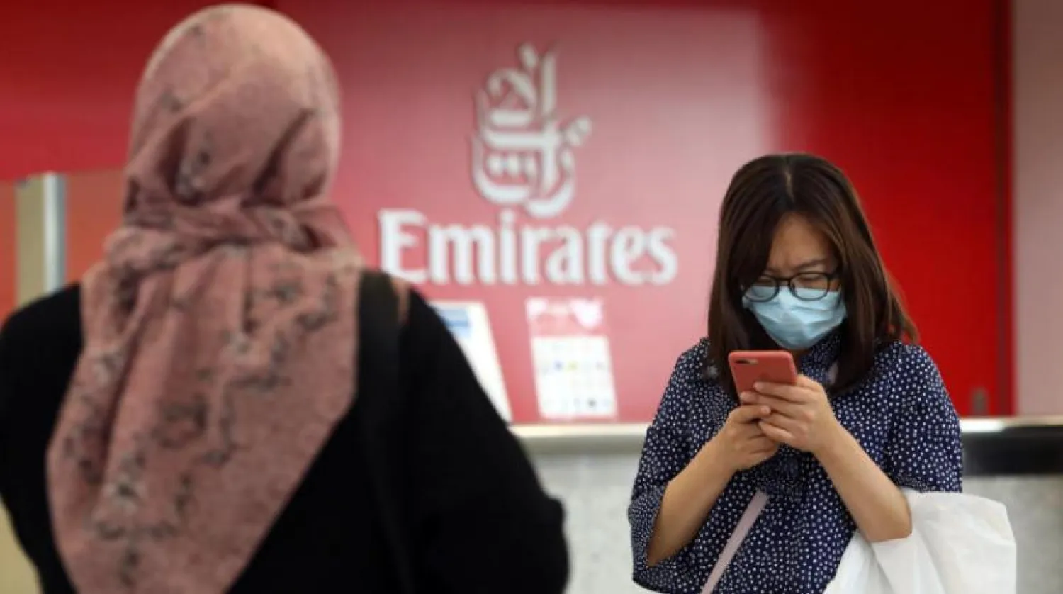 A traveller wears a mask at the Dubai International Airport, in Dubai, United Arab Emirates January 29, 2020. REUTERS/Christopher Pike