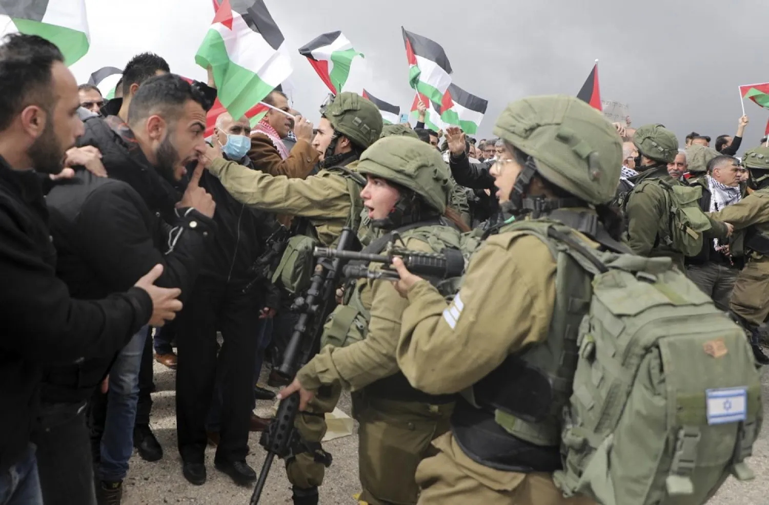 Palestinian protesters confront Israeli soldiers during a demonstration in the West Bank against US President Donald Trump's peace proposals, on January 29, 2020. (AFP)