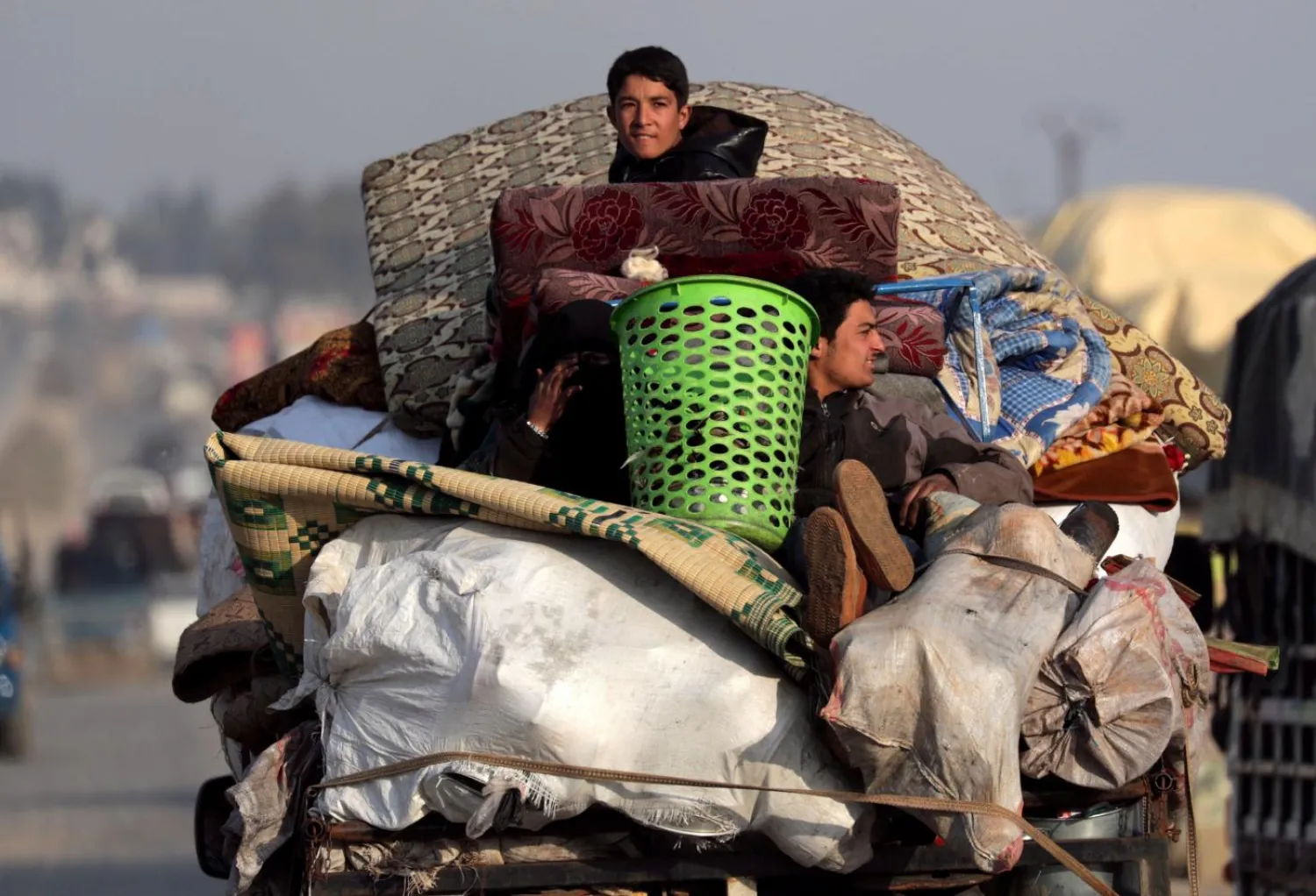 Displaced Syrians from northwest Syria ride on a truck with belongings. Reuters file photo