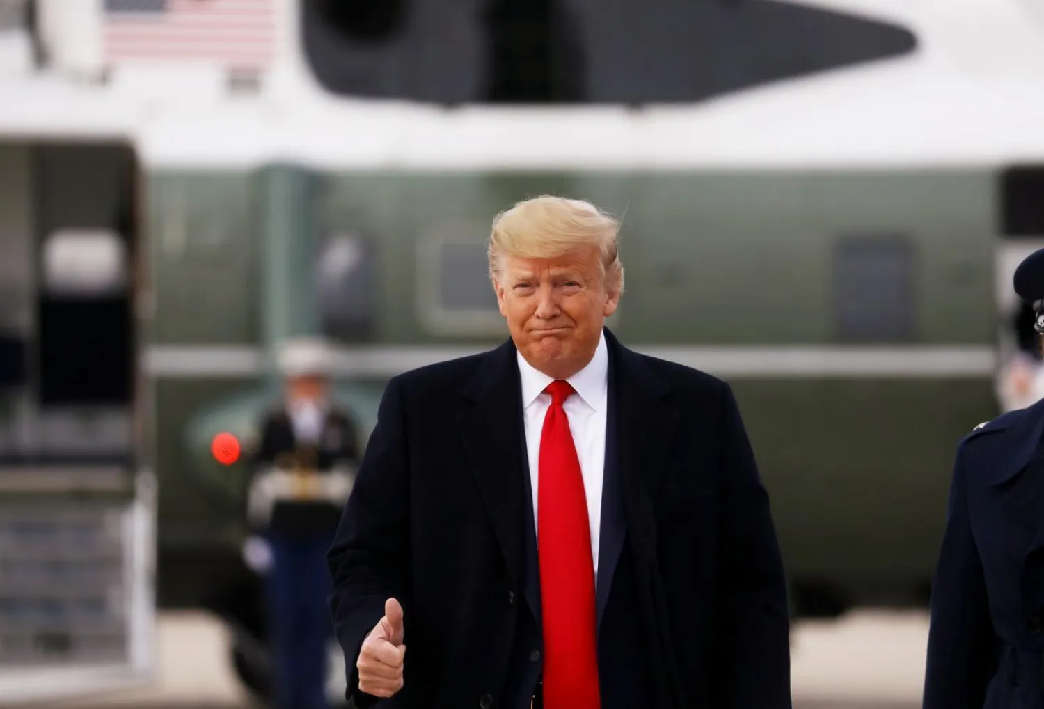 FILE PHOTO: US President Donald Trump gives a thumbs up as he boards Air Force One for travel to Florida at Joint Base Andrews, Maryland, US January 23, 2020. REUTERS/Leah Millis
