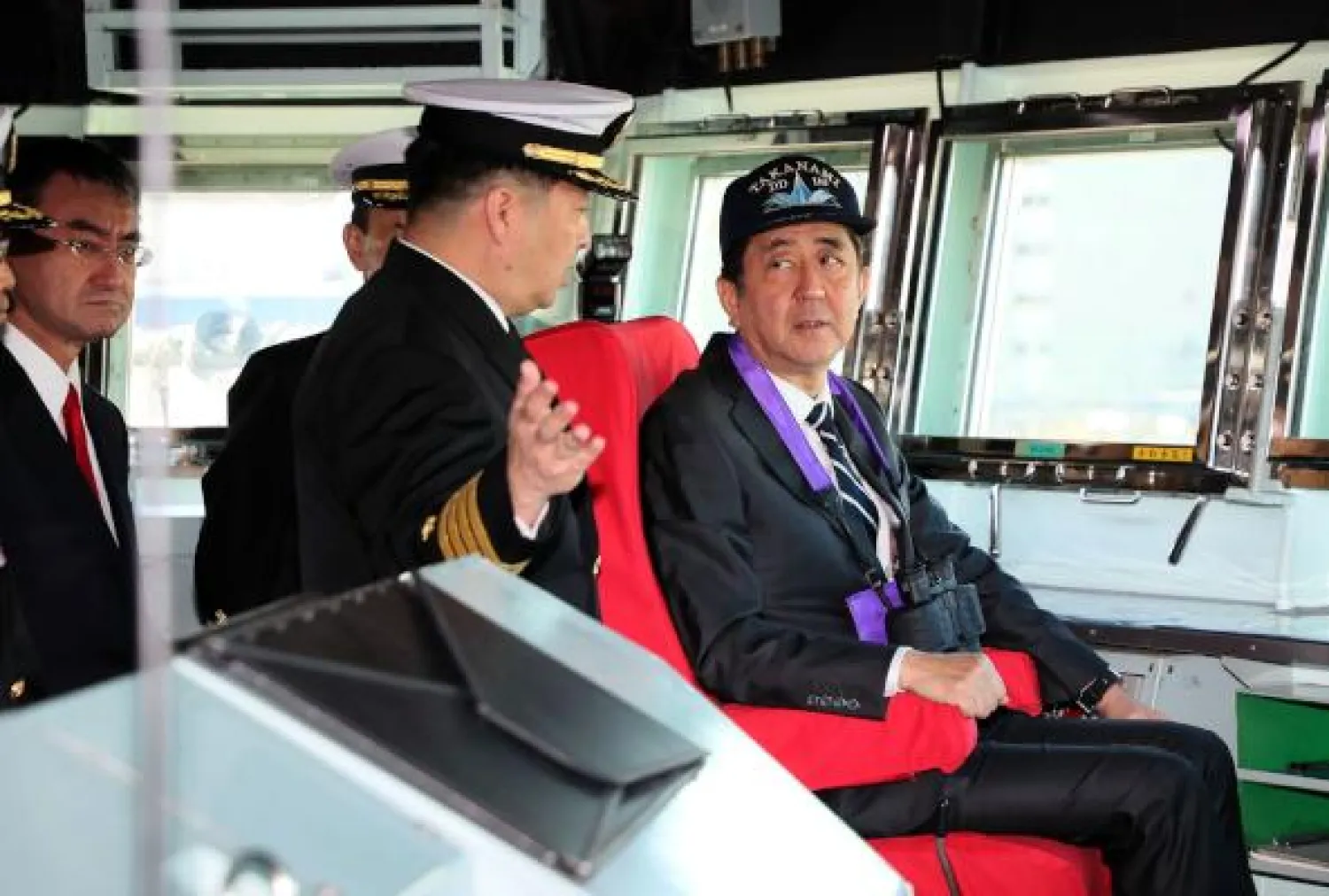 Japan's Prime Minister Shinzo Abe (R) listens during a tour of the ship ahead of the departure of Japan's Maritime Self-Defence Force destroyer "Takanami" for the Middle East, at Yokosuka Naval Base in Yokosuka, Kanagawa prefecture on February 2, 2020. - Japan dispatched the naval destroyer to Middle East for a rare overseas mission to ensure safety of Japanese ships amid lingering tension between Iran and the US. (Photo by STR / JIJI PRESS / AFP) / Japan OUT

