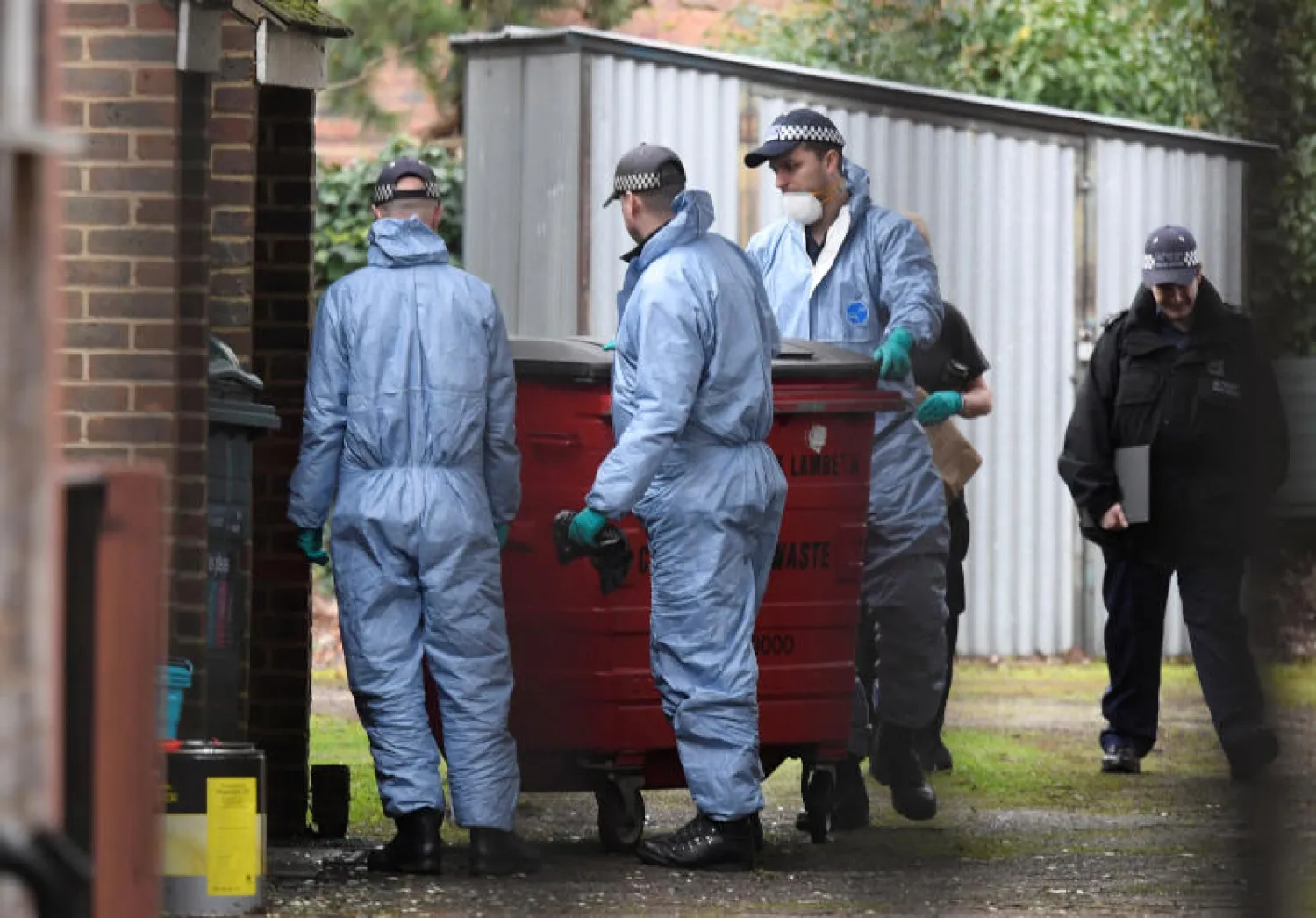 خبراء الأدلة الجنائية يعاينون منزلاً في لندن دهمته الشرطة (رويترز)