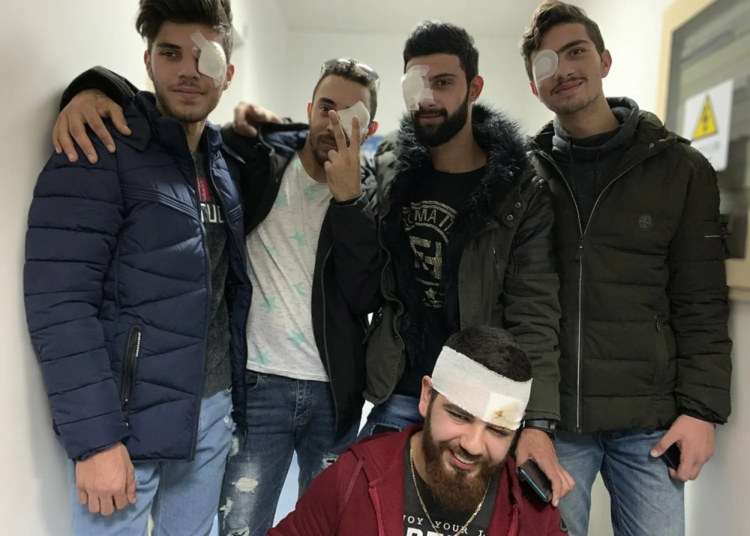 In this Jan. 27, 2020 photo, anti-government protesters, who were injured during clashing with riot police, pose for a group picture after a check-up at a hospital in Beirut, Lebanon. (AP)