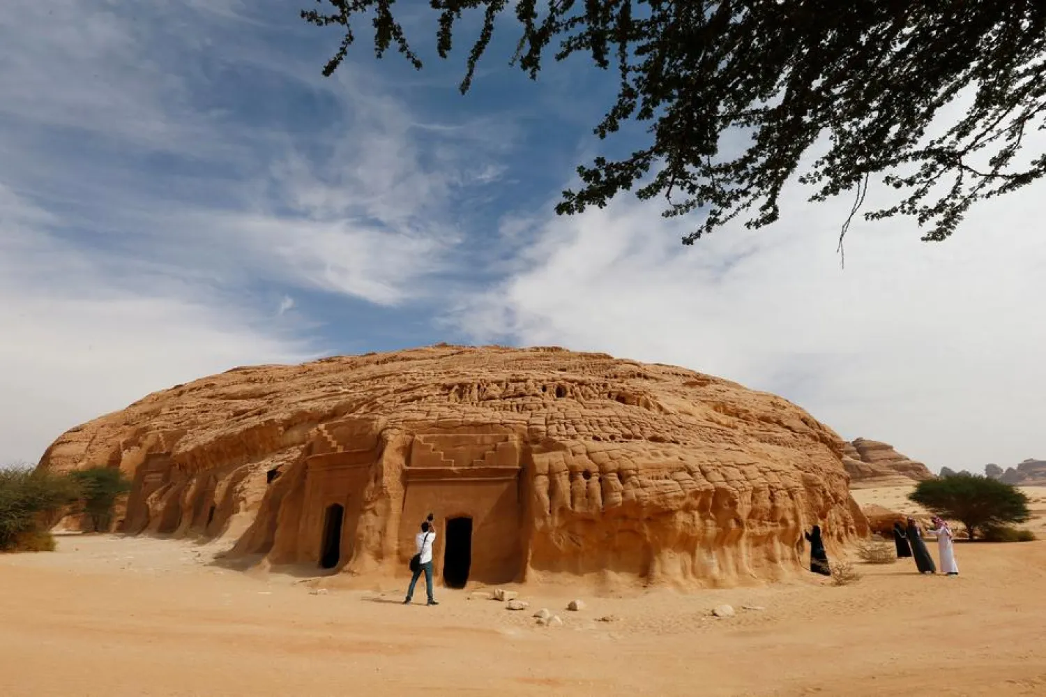 Visitors take pictures at majestic rock-hewn tombs of Madain Saleh near the city al-Ula, Saudi Arabia January 25, 2019. Picture taken January 25, 2019. REUTERS/Faisal Al Nasser