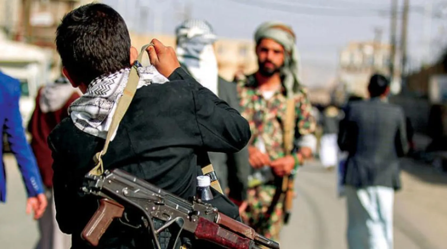 Two Houthi gunmen in a gathering organized by the group in Sanaa (AFP)