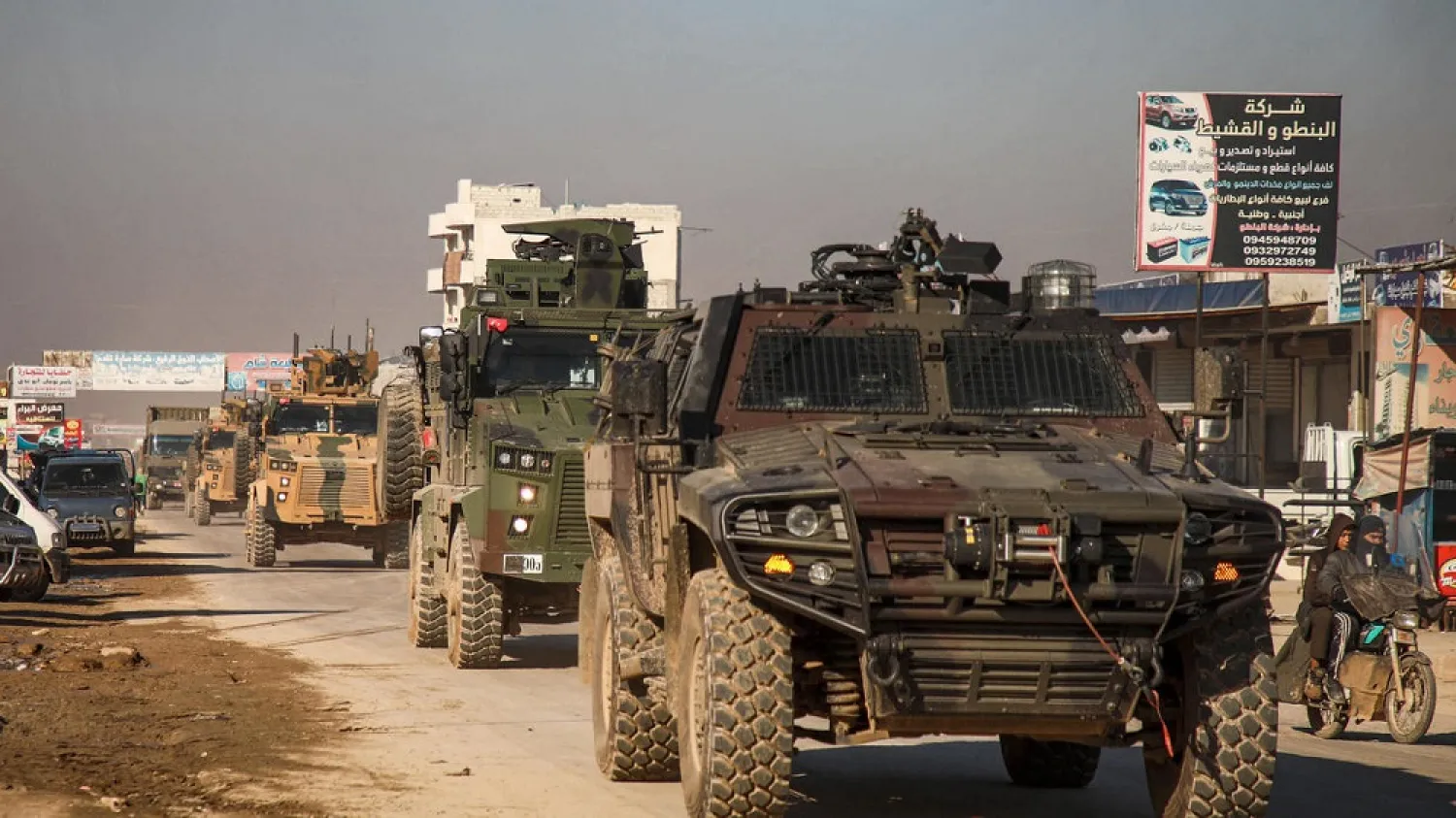 A Turkish military convoy of tanks and armored vehicles passes through the Syrian town of Dana, east of the Turkish-Syrian border in the northwestern Syrian province of Idlib, on February 2, 2020. (AFP)