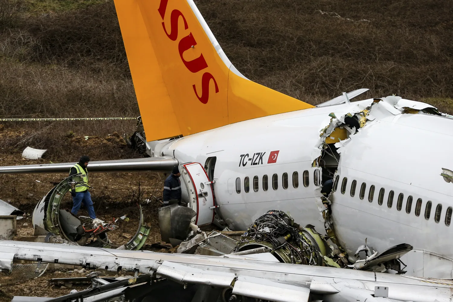 Officials work on the wreckage of a plane operated by Pegasus Airlines after it skidded Wednesday off the runway at Istanbul’s Sabiha Gokcen Airport, in Istanbul, Thursday, Feb. 6, 2020. (Emrah Gurel/Associated Press)