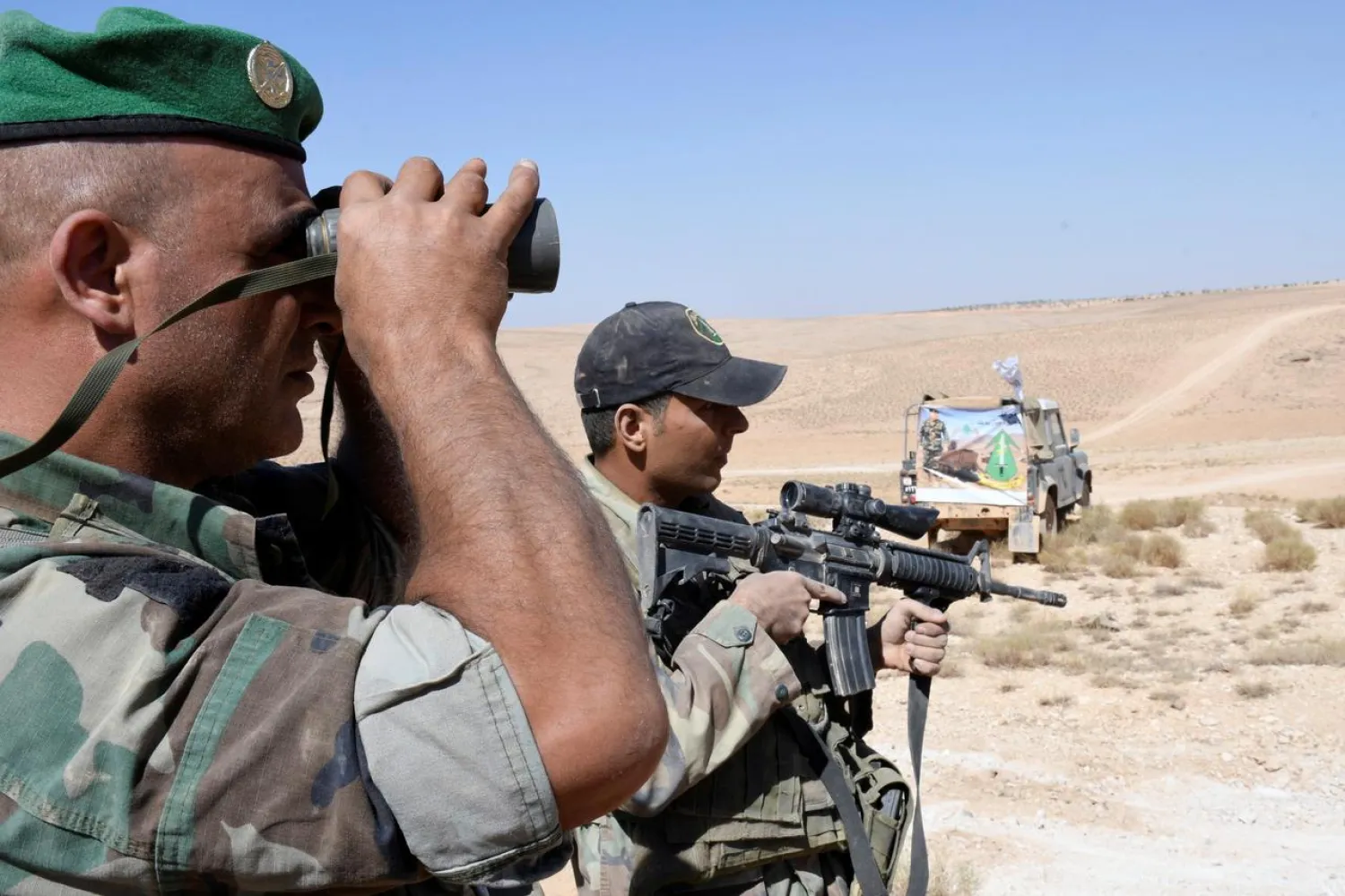 A Lebanese army soldier looks through binoculars in Ras Baalbek, Lebanon August 28, 2017. (Reuters)