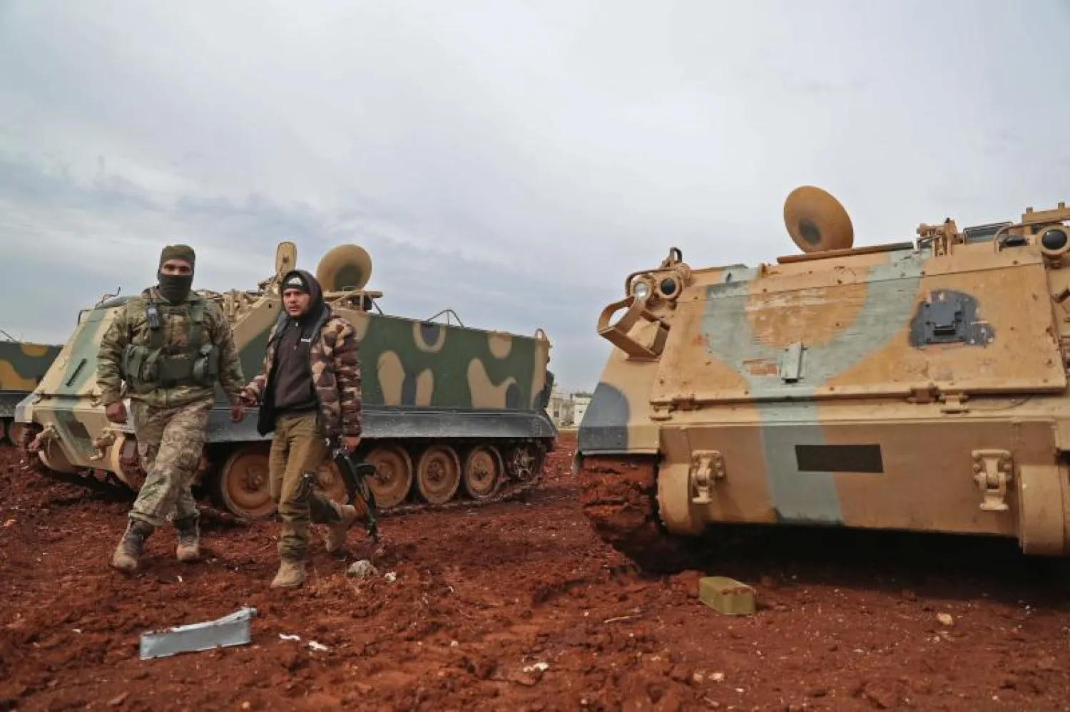 مقاتلان سوريان مدعومان من تركيا في بلدة سرمين في إدلب (أ.ف.ب)