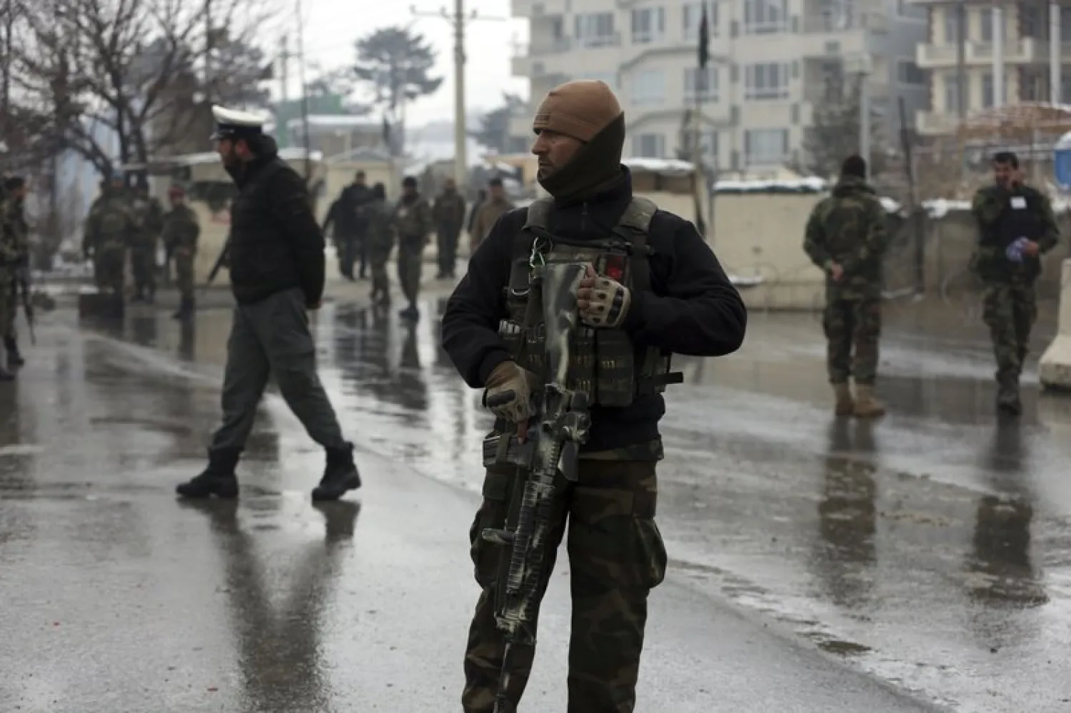 National army soldiers stand guard at the site of a suicide attack near the military academy in Kabul, Afghanistan, Tuesday, Feb. 11, 2020. (AP Photo/Rahmat Gul)