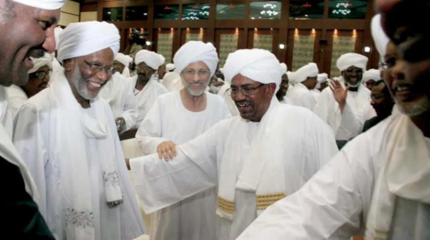 Bashir, al-Turabi and al-Atabani, during a conference in 2014. Getty Images