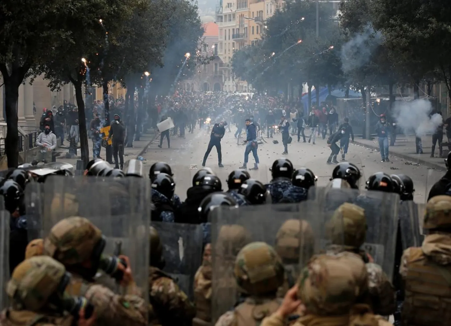 Riot police fire tear gas canisters towards anti-government protesters, in downtown Beirut, Lebanon, Tuesday, Feb. 11, 2020. Lebanese security forces fired tear gas to disperse thousands of protesters near the parliament building in Beirut, where the new Cabinet was expanding on its policy statement on Tuesday ahead of a confidence vote by lawmakers. (AP Photo/Hussein Malla)