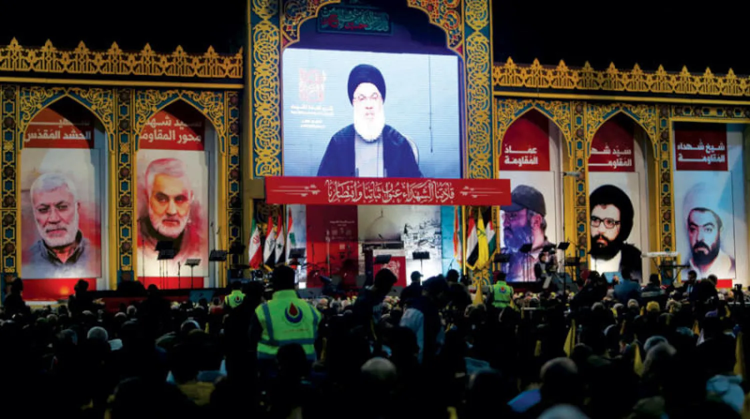 أمين عام «حزب الله» حسن نصر الله متحدثاً عبر شاشة في «ذكرى الشهداء»... (رويترز)