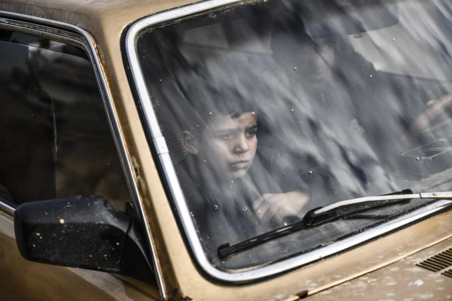 Civilians flee from Idlib toward the north to find safety inside Syria near the border with Turkey, Saturday, Feb. 15, 2020. (AP)