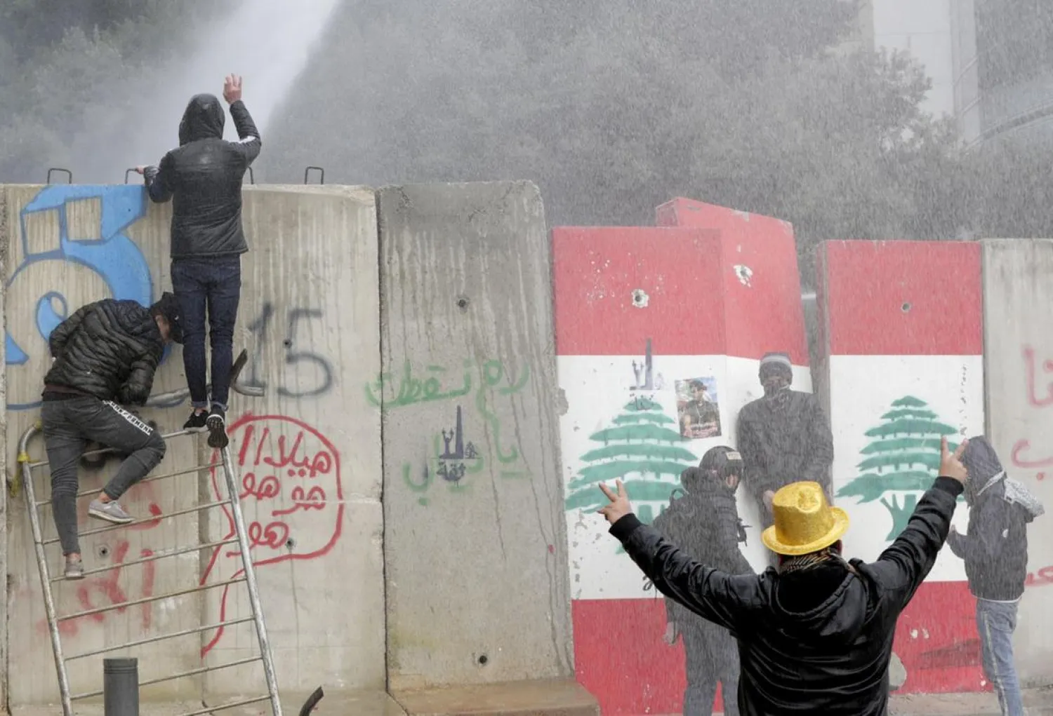 Lebanese security forces use water cannon to disperse protesters gathered in the heart of Beirut to stop a confidence vote for a new government. (AFP)
