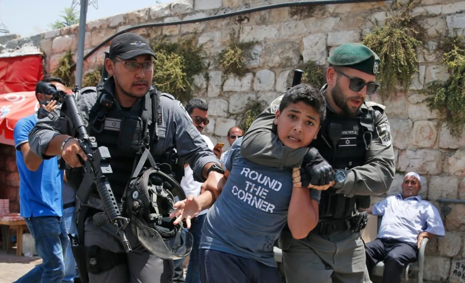  Israeli occupation forces dragging a child to prison (AFP)