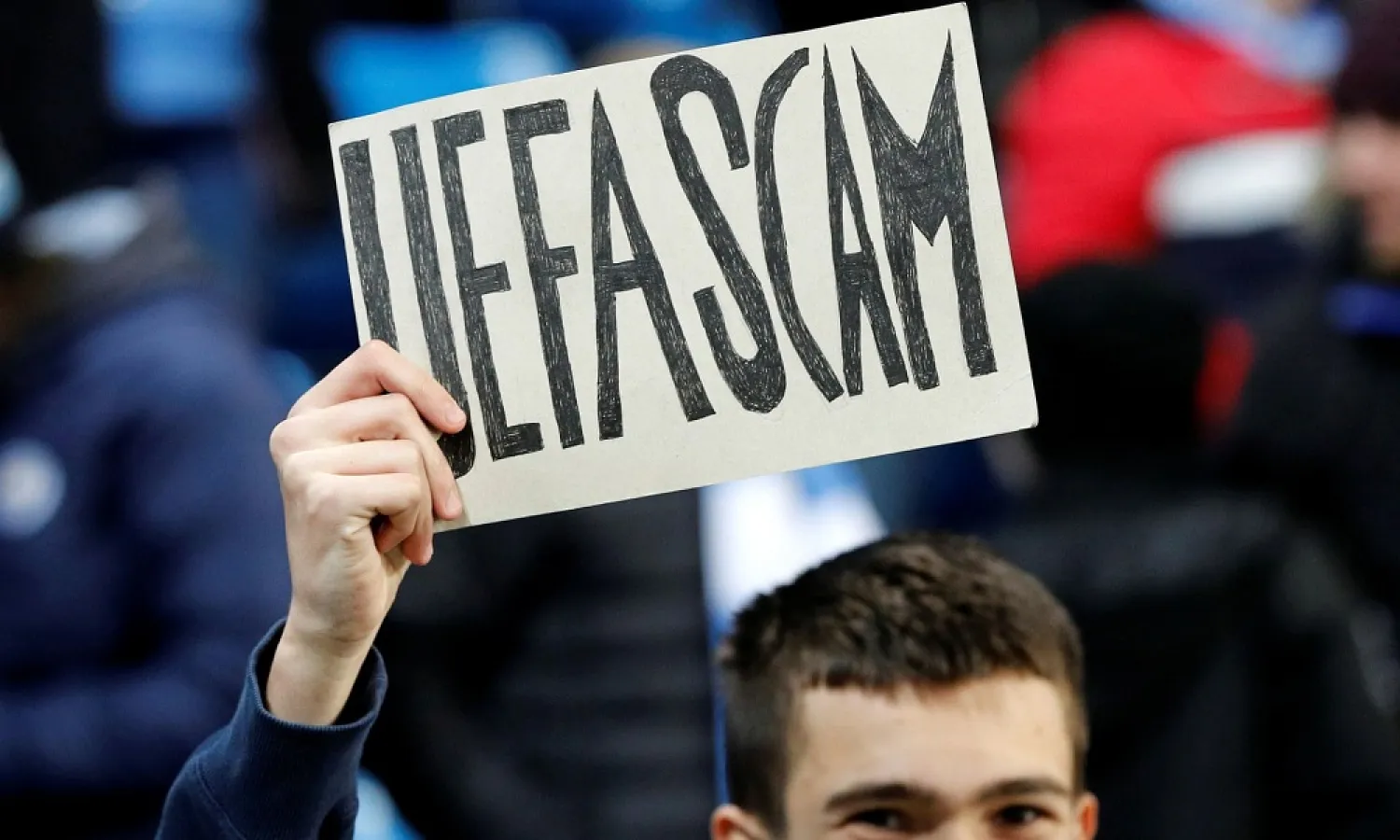 A Manchester City fan holds up a sign before the match against West Ham. (Reuters)