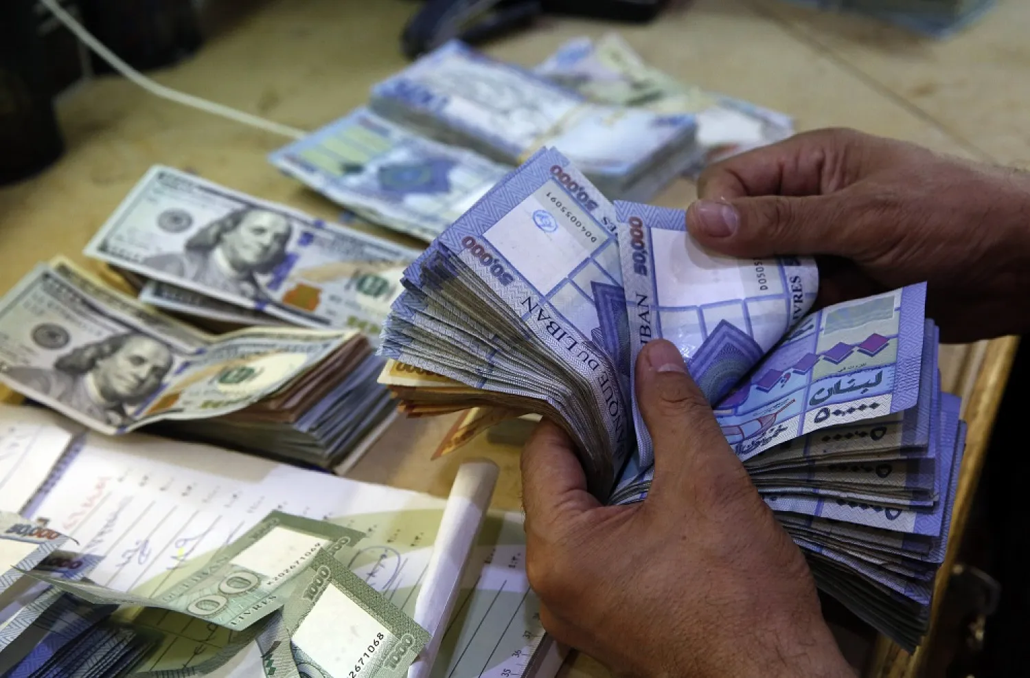 In this Monday Aug. 20, 2018 photo, a man counts Lebanese pounds at an exchange shop, in Beirut, Lebanon. (AP)