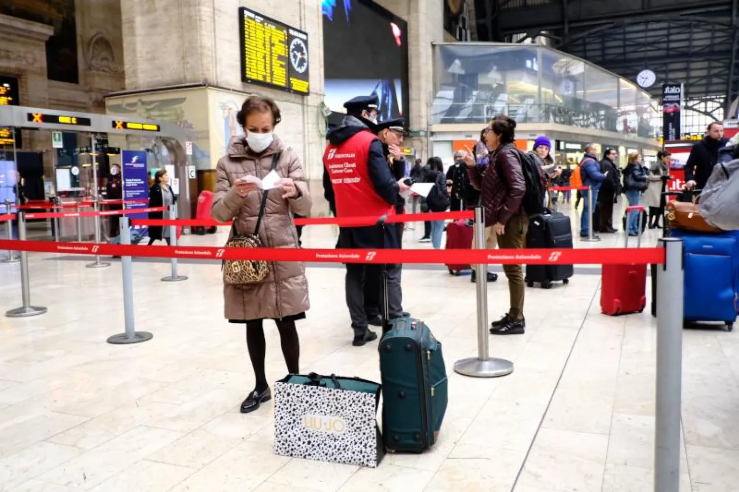 ركاب ينتظرون في محطة السكة الحديد الرئيسية في ميلانو(ا.ف.ب)