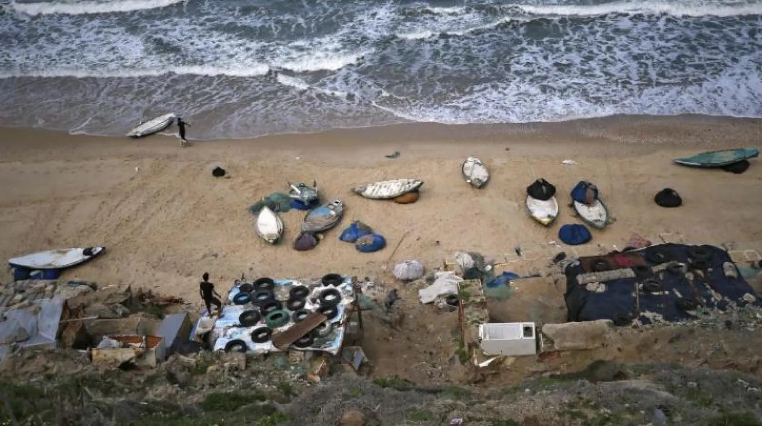 Palestinian fishermen pull their boats to shore after Israel announced the closure of the fishing area in Gaza (AFP)