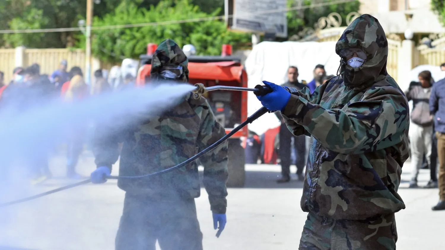 Civil defense teams disinfect a seminary in the city of Najaf where Islamic students are believed to have come in contact with Iraq's first confirmed case of novel coronavirus | AFP
