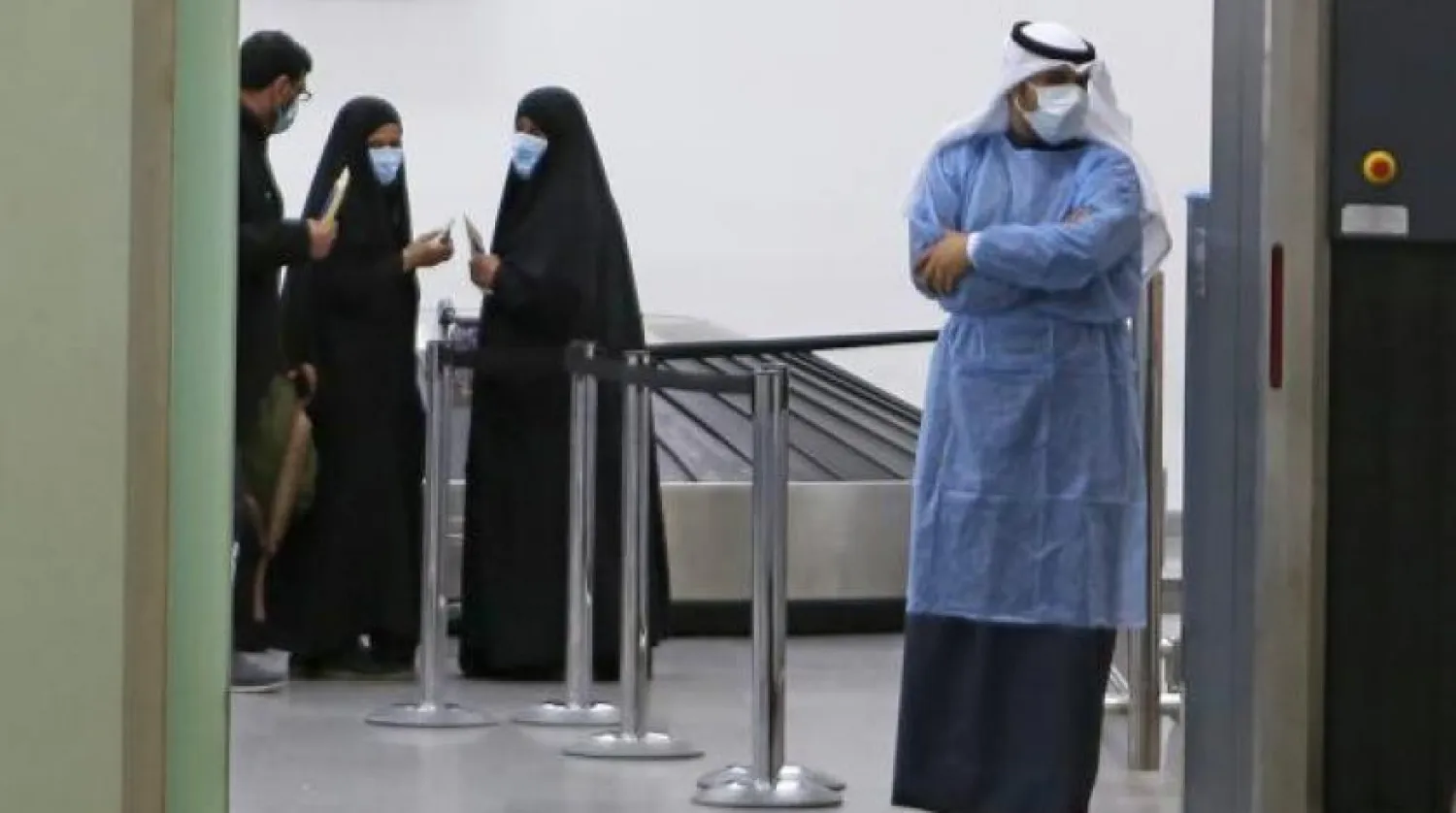 Kuwaitis coming back from Iran wait at Sheikh Saad Airport in Kuwait City, on February 22, 2020, before being taken to a hospital to be tested for coronavirus. (Photo by YASSER AL-ZAYYAT / AFP)