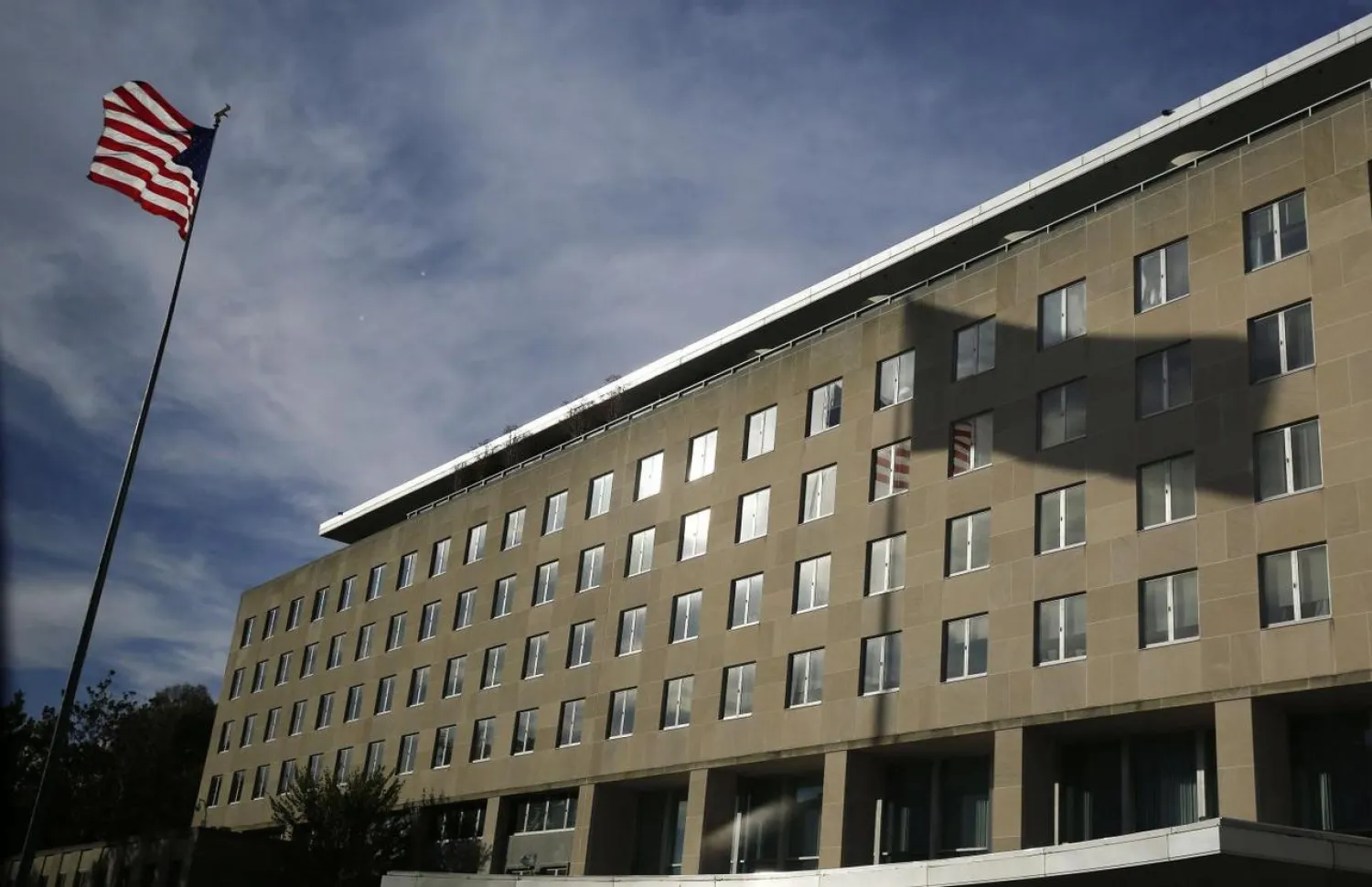 A US national flag and its shadow on the Harry S. Truman Building at the Department of State are pictured in Washington, in this October 24, 2014 file photo. REUTERS/Larry Downing/Files