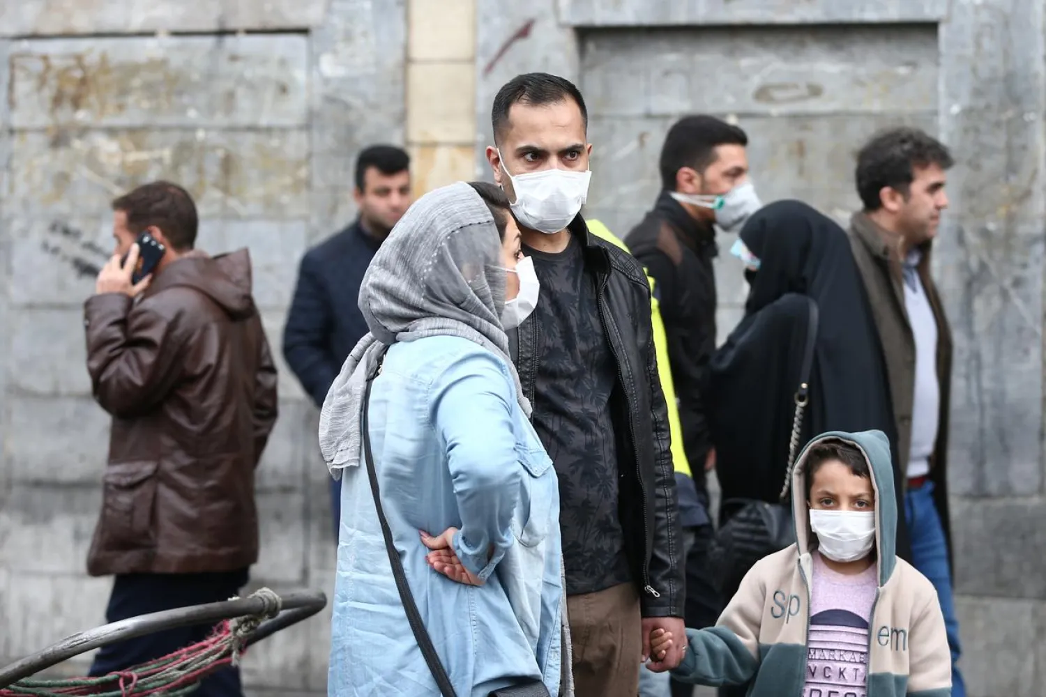 Iranian family wear protective masks to prevent contracting a coronavirus, as they stand at Grand Bazaar in Tehran, Iran February 20, 2020. WANA (West Asia News Agency)/Nazanin Tabatabaee via REUTERS
