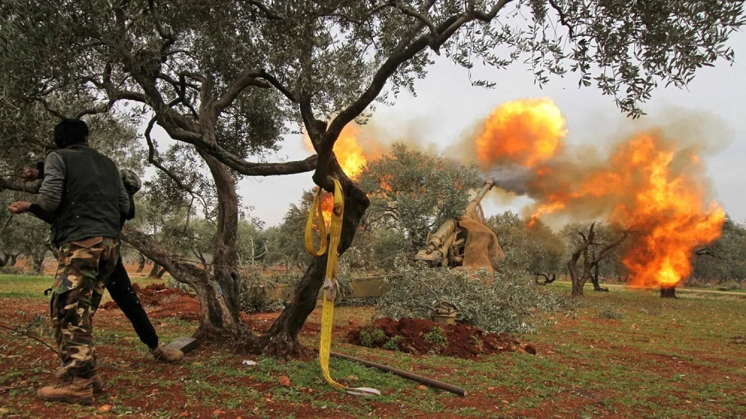 Turkish-backed Syrian opposition fighters fire heavy artillery guns at regime forces near the town Taftanaz, Idlib province on Friday. (Getty Images)