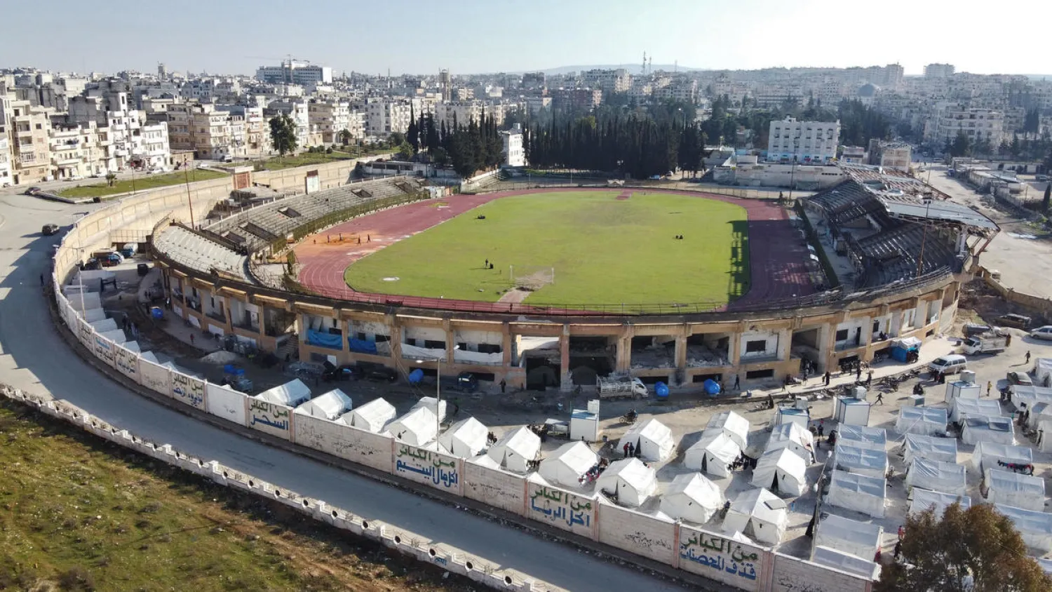 Displaced Syrian families are living in tents at a football stadium in Idlib city. (AFP)