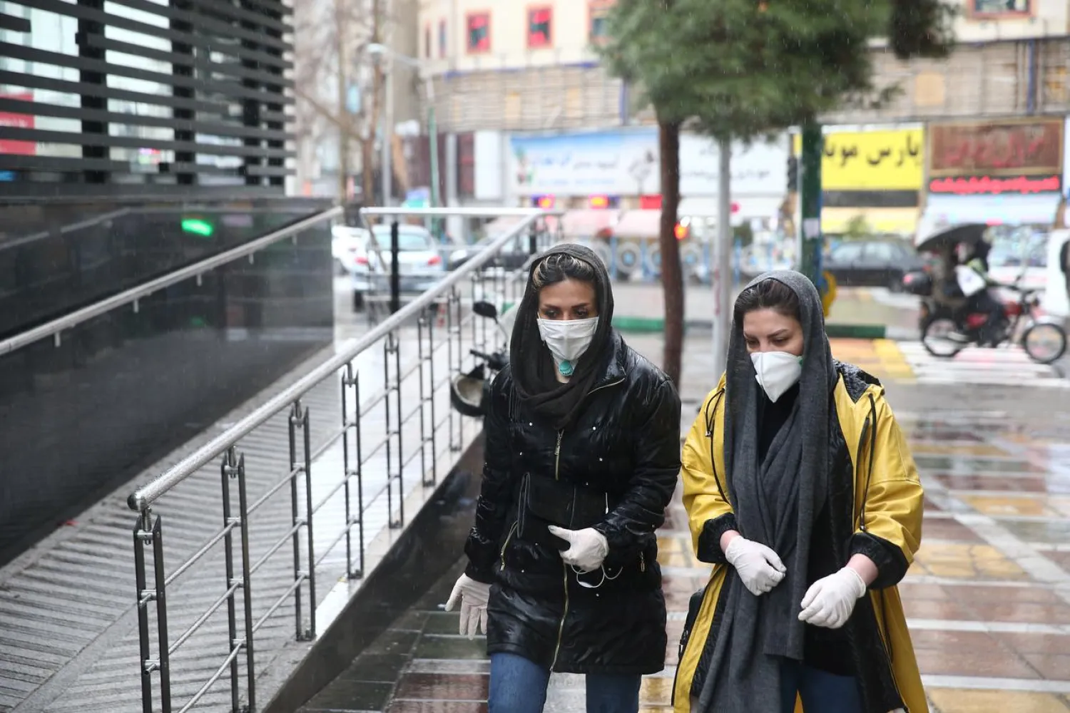 FILE PHOTO: Iranian women wear protective masks to prevent contracting a coronavirus, as they walk in the street in Tehran, Iran February 25, 2020. WANA (West Asia News Agency)/Nazanin Tabatabaee via REUTERS