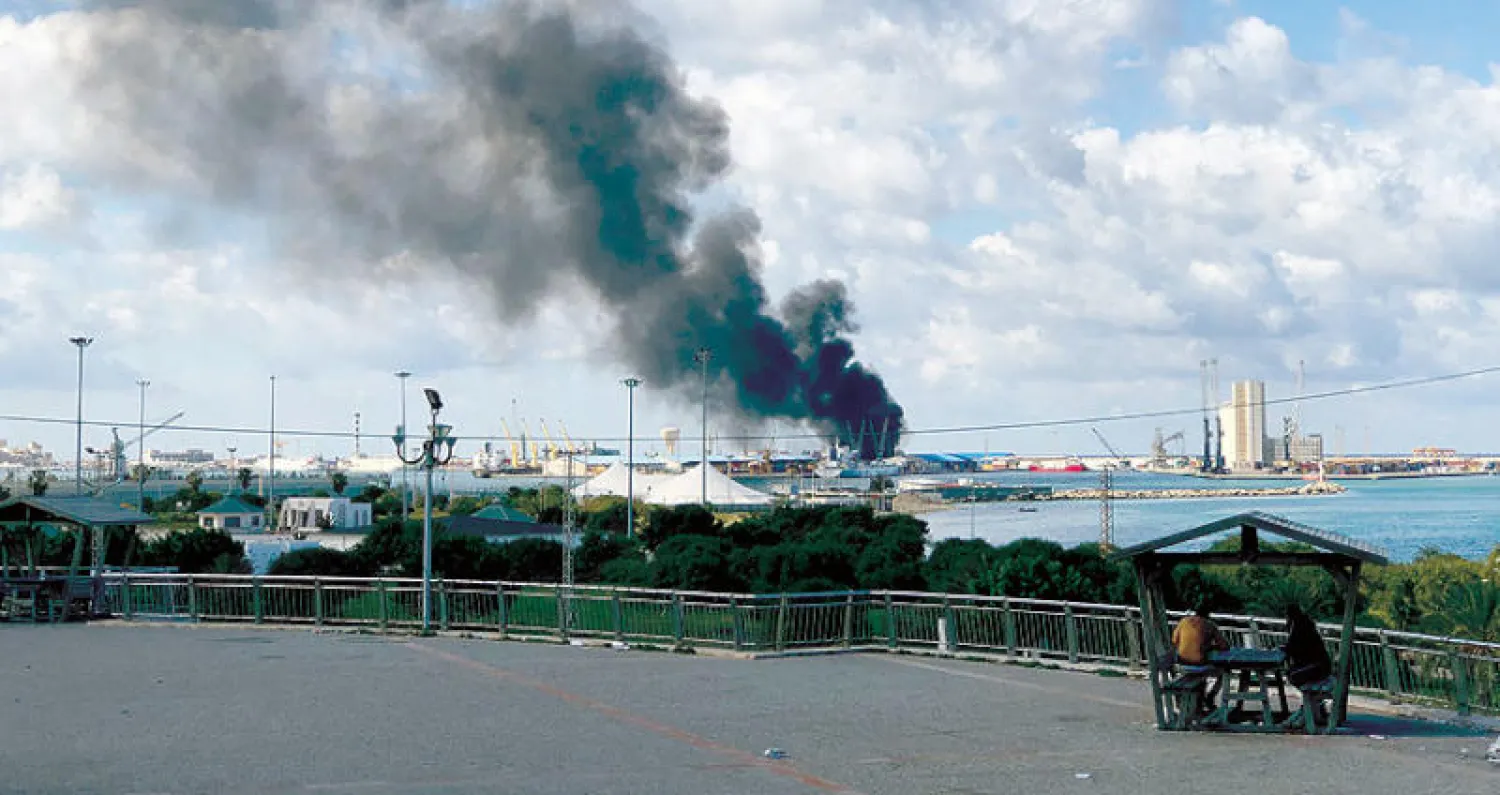 دخان يتصاعد من مرفأ طرابلس بعد تعرضه للقصف قبل أسبوعين (رويترز)