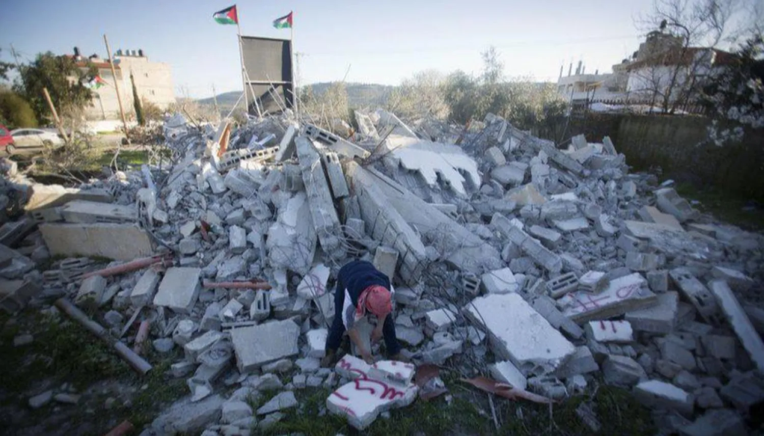 A Palestinian inspects family apartment of Yazan Mughamis demolished by the Israeli army, in the West Bank city of Ramallah, Thursday, March 5, 2020. (AP Photo/Majdi Mohammed)