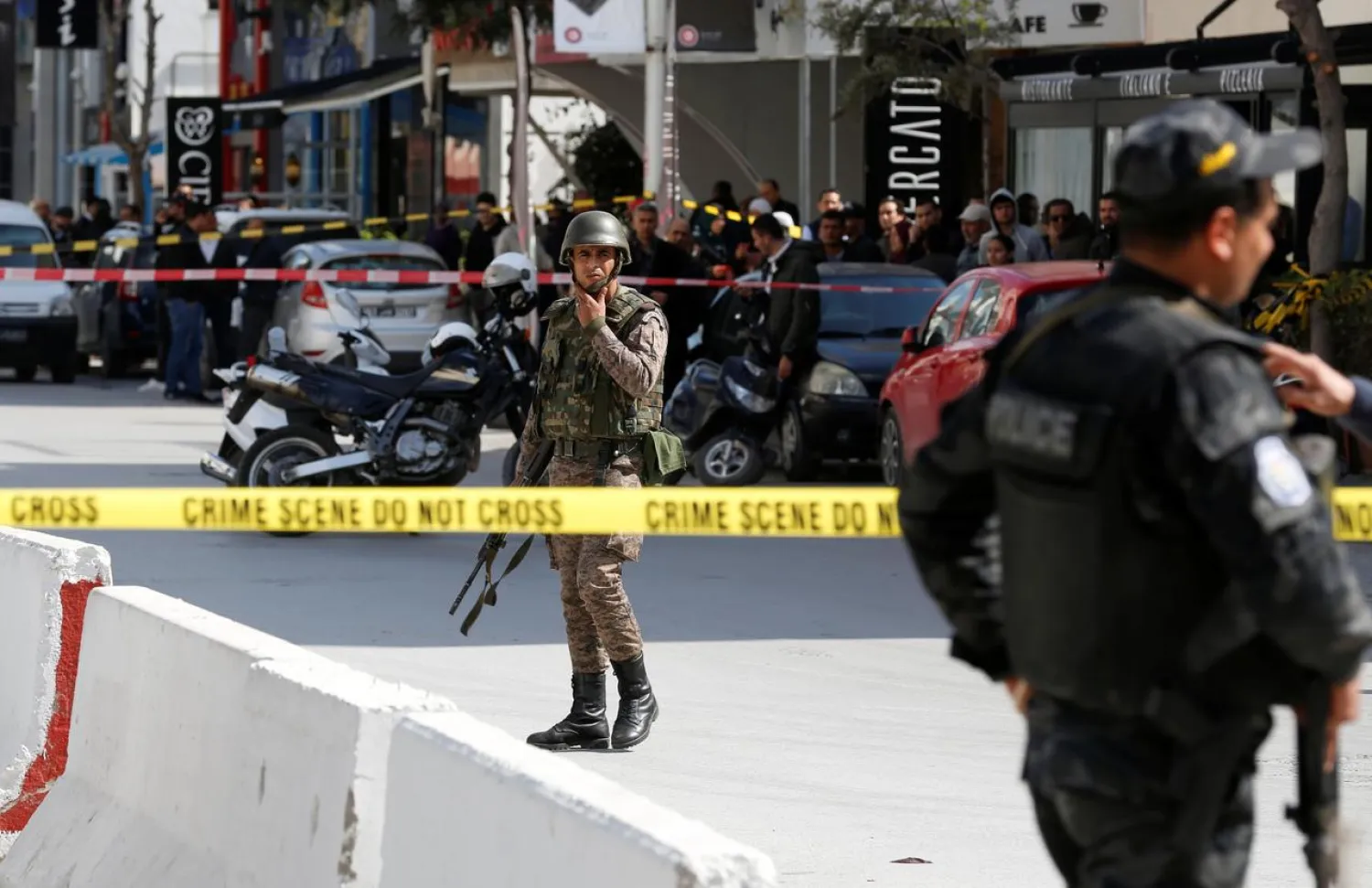 A police officer and soldier stand at the site of the suicide attack near the US Embassy in Tunis, Tunisia. (Reuters)