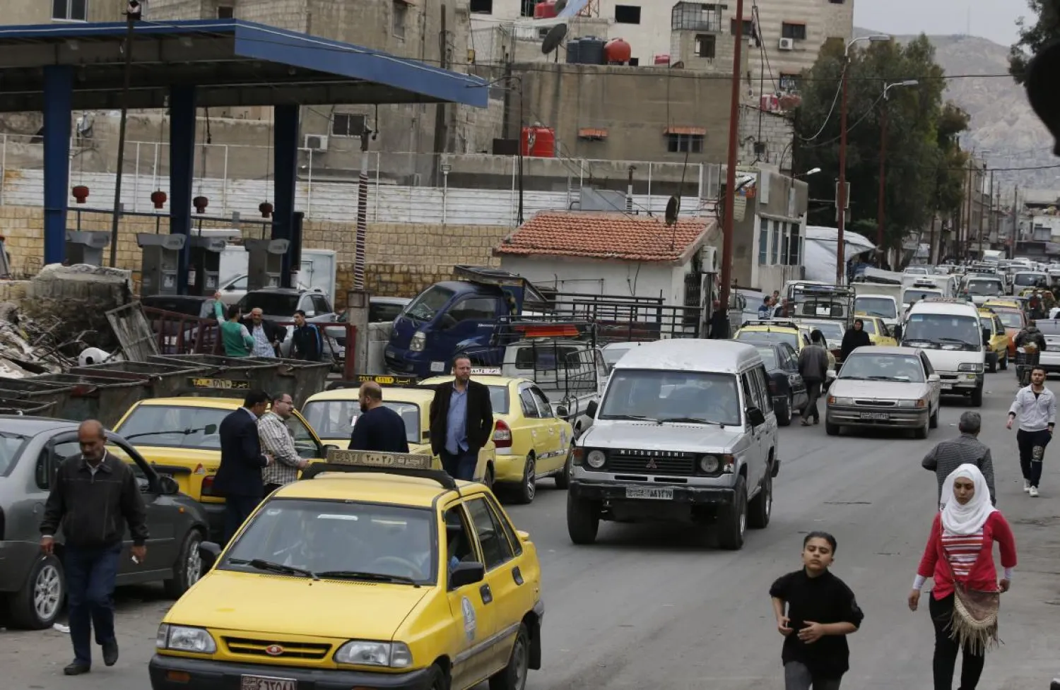 Drivers queue for gasoline in front of a petrol station in the Syrian capital Damascus on April 15, 2019. (AFP)