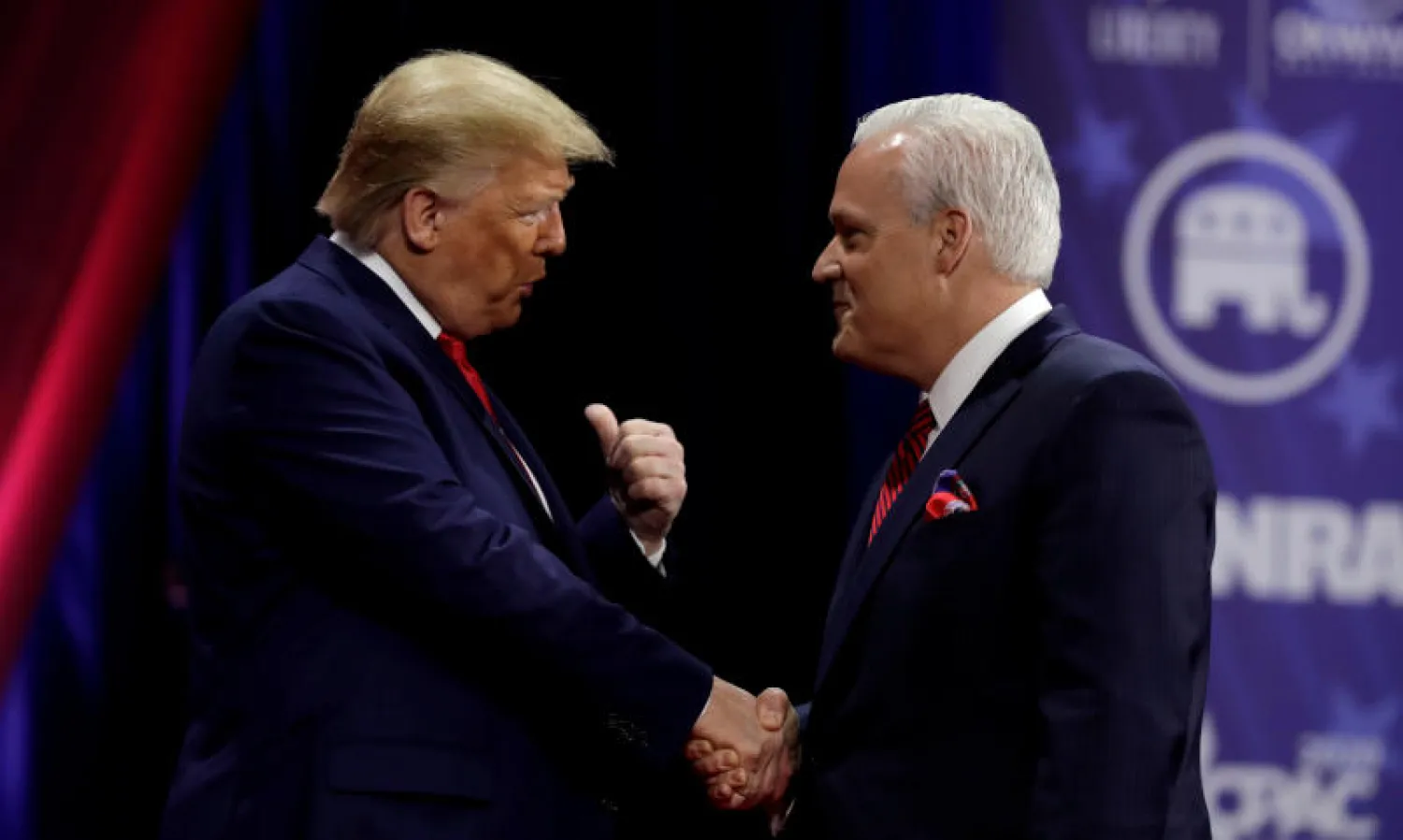 الرئيس الأميركي دونالد ترمب يصافح رئيس اتحاد المحافظين الأميركيين مات شلاب الذي تفاعل مع الشخص المؤكد إصابته بـ«كورونا» (رويترز)