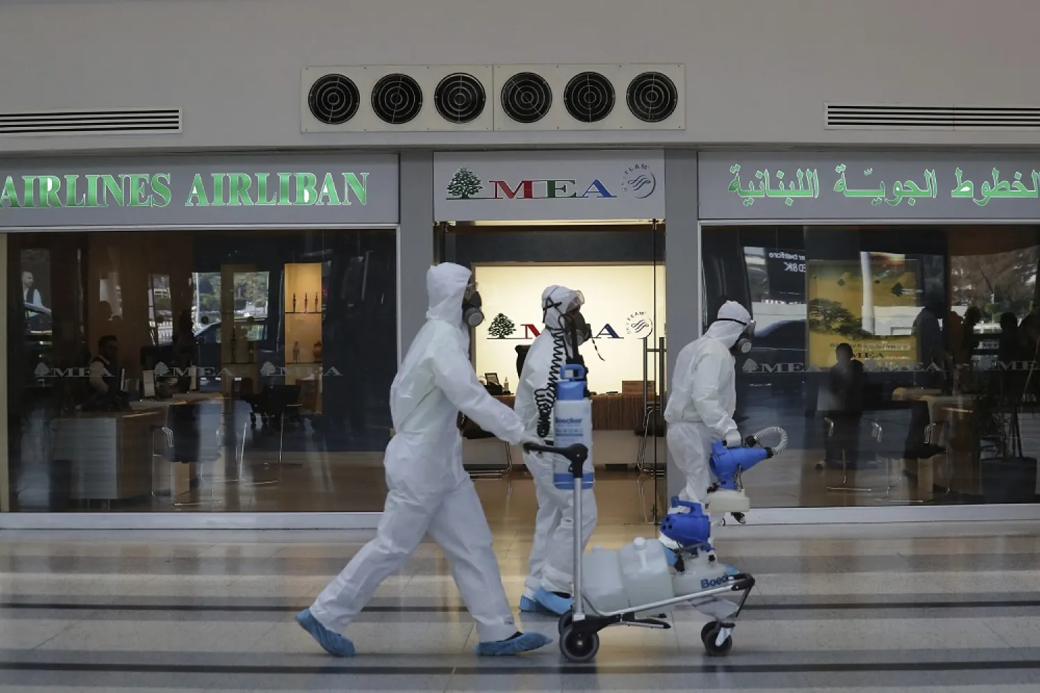 Workers wearing protective gear spray disinfectant as a precaution against the coronavirus outbreak, at the Rafik Hariri International Airport, in Beirut, Lebanon, Thursday, March 5, 2020. (AP)
