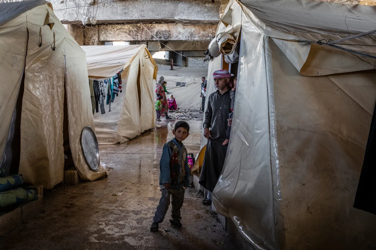 About 100 displaced families live in a temporary shelter in a soccer stadium in Idlib city. The city is likely to be the Syrian government’s next target.Credit...Ivor Prickett for The New York Times