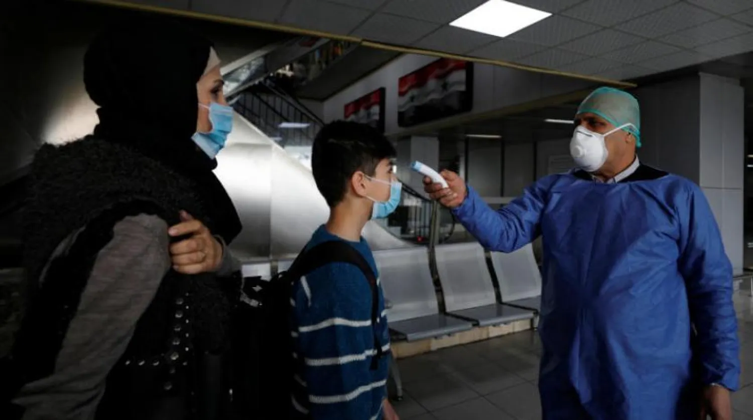 Doctors checking travelers in Damascus airport. Reuters 