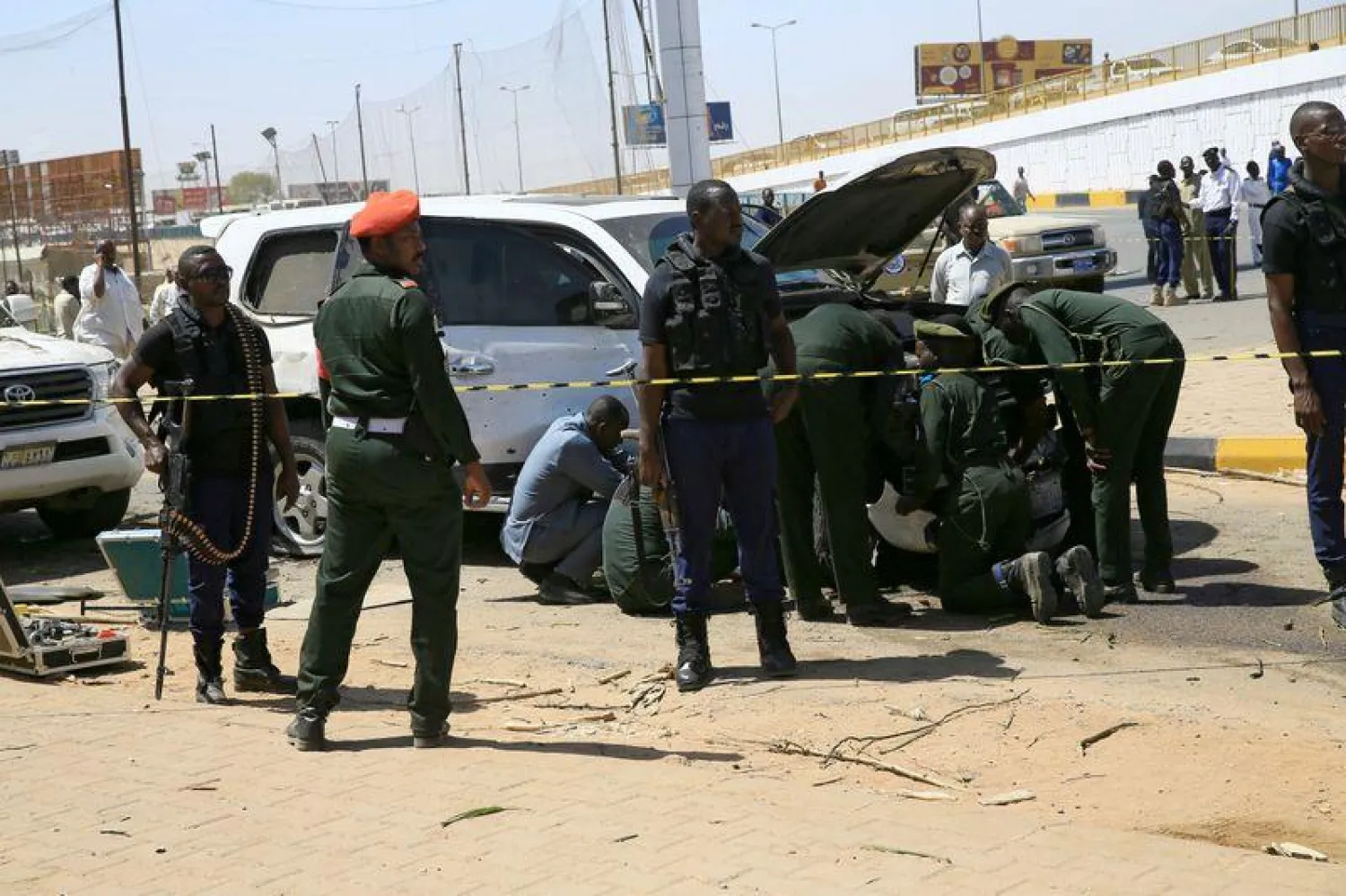 Security personnel stand near a car damaged after an explosion targeting the motorcade of Sudan's Prime Minister Abdalla Hamdok near the Kober Bridge in Khartoum, Sudan (File photo: Reuters)
