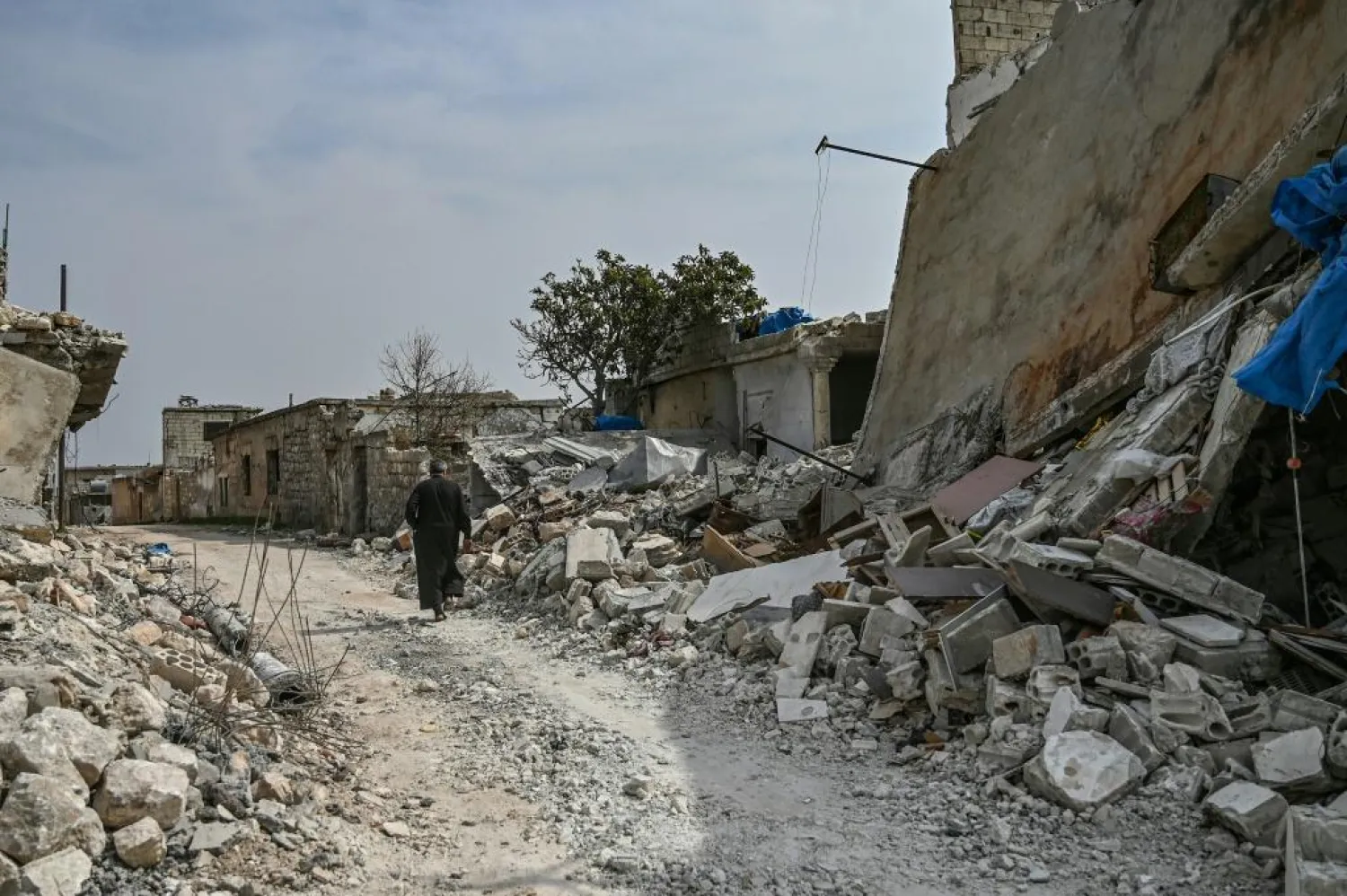 A man walks in al-Mastuma, about seven kilometers south of Idlib city in northwest Syria, on March 10 | AFP