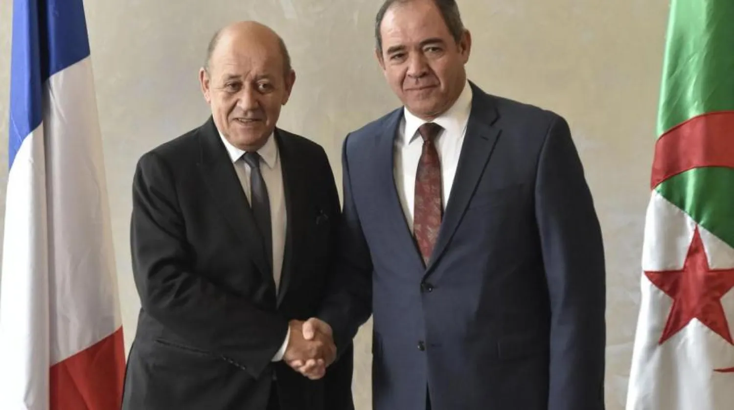 Algerian Foreign Minister Sabri Boukadoum (R) receives French Foreign Minister Jean-Yves Le Drian in the capital Algiers, on January 21, 2020. (AFP)