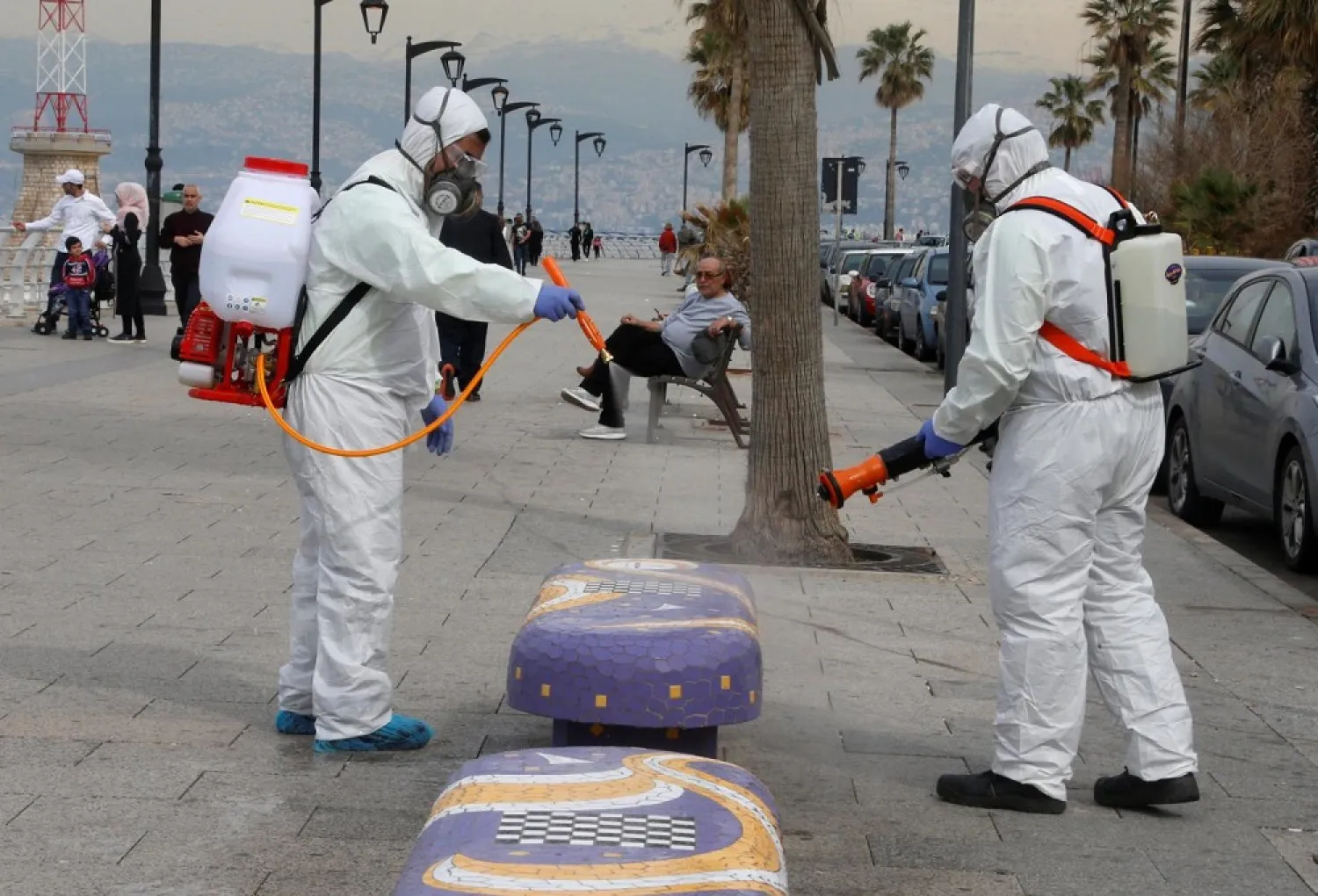 Employees from a disinfection company sanitize a bench as a precaution against the spread of the coronavirus at Beirut's seaside Corniche on March 5. (Reuters)