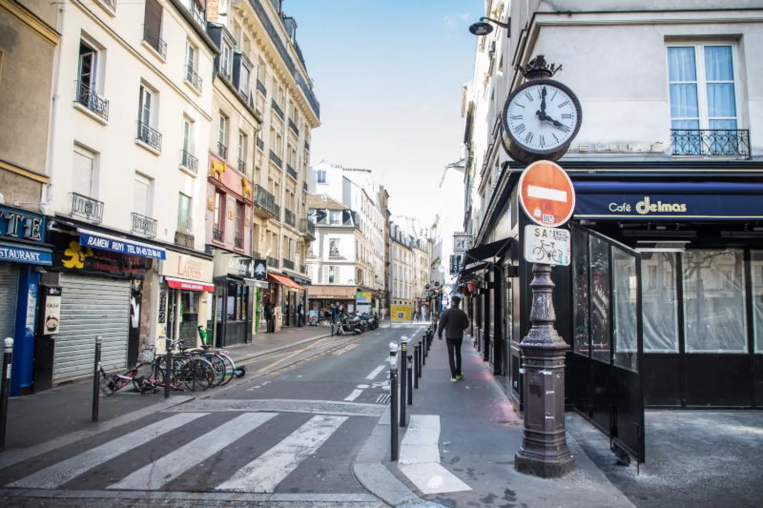 رجل يسير في شوارع باريس الخالية بسبب كورونا (أ.ب.إ)