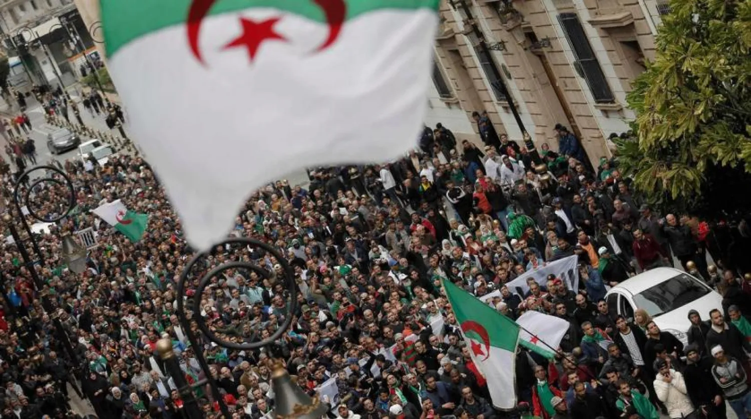 Algerians take to the streets in the capital Algiers to protest against the government. (AP)
