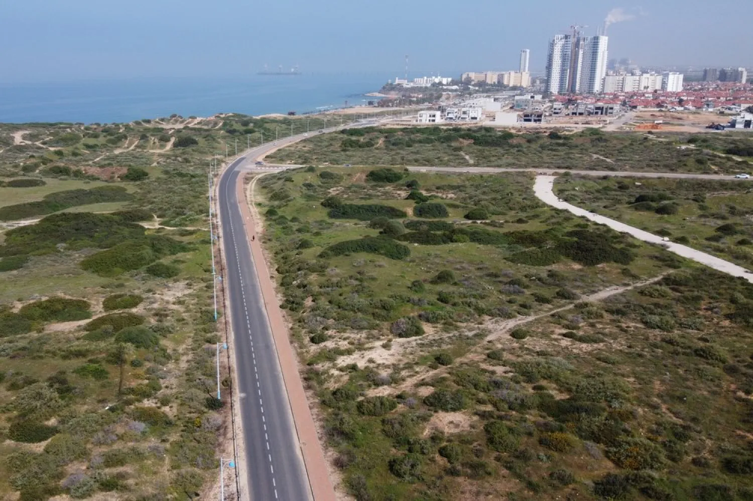 A person walks through an empty avenue in Hadera, Israel, Monday, March 16, 2020. (AP)