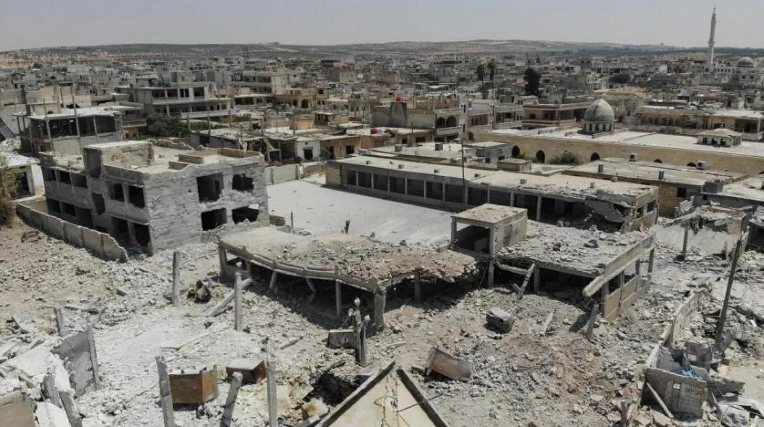 An aerial view taken on August 3, 2019, shows destroyed buildings in the town of Khan Sheikhoun in the southern countryside of Idlib | (AFP)
