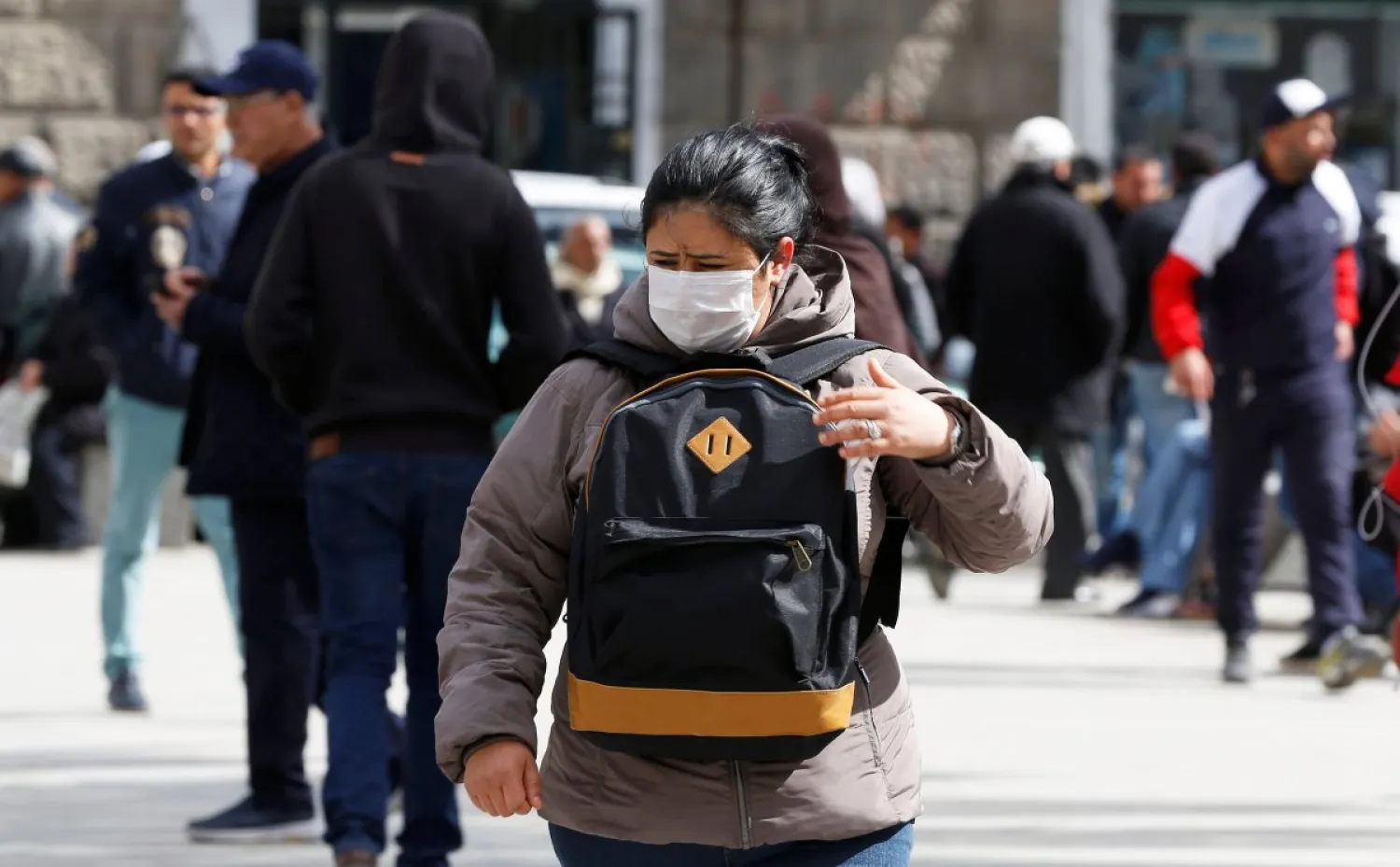 A woman wears a protective face mask as she walks in Tunis, Tunisia, on March 3, 2020. (Reuters)