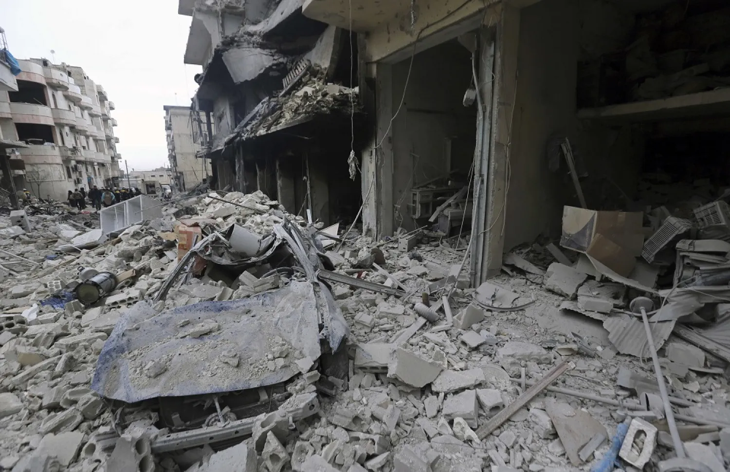 People inspect a damaged site after airstrikes on the town of Ariha, in Idlib, Syria, Jan. 30, 2020. (AP)